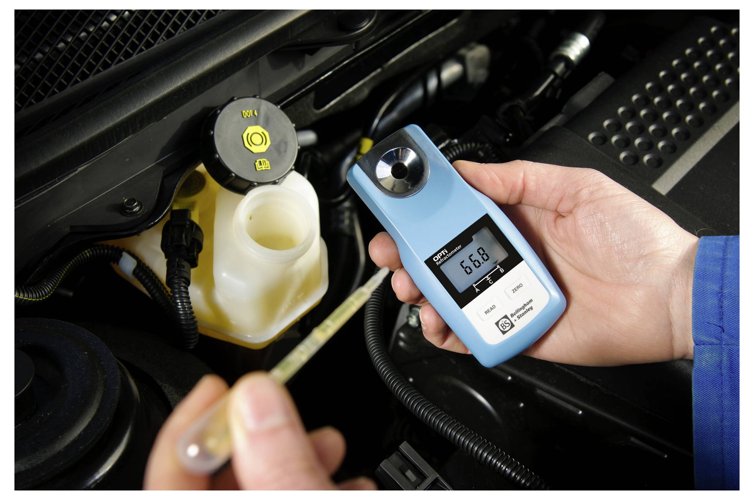 A person holding a digital refractometer showing a reading of 6.8 next to an open coolant reservoir in a car engine bay.