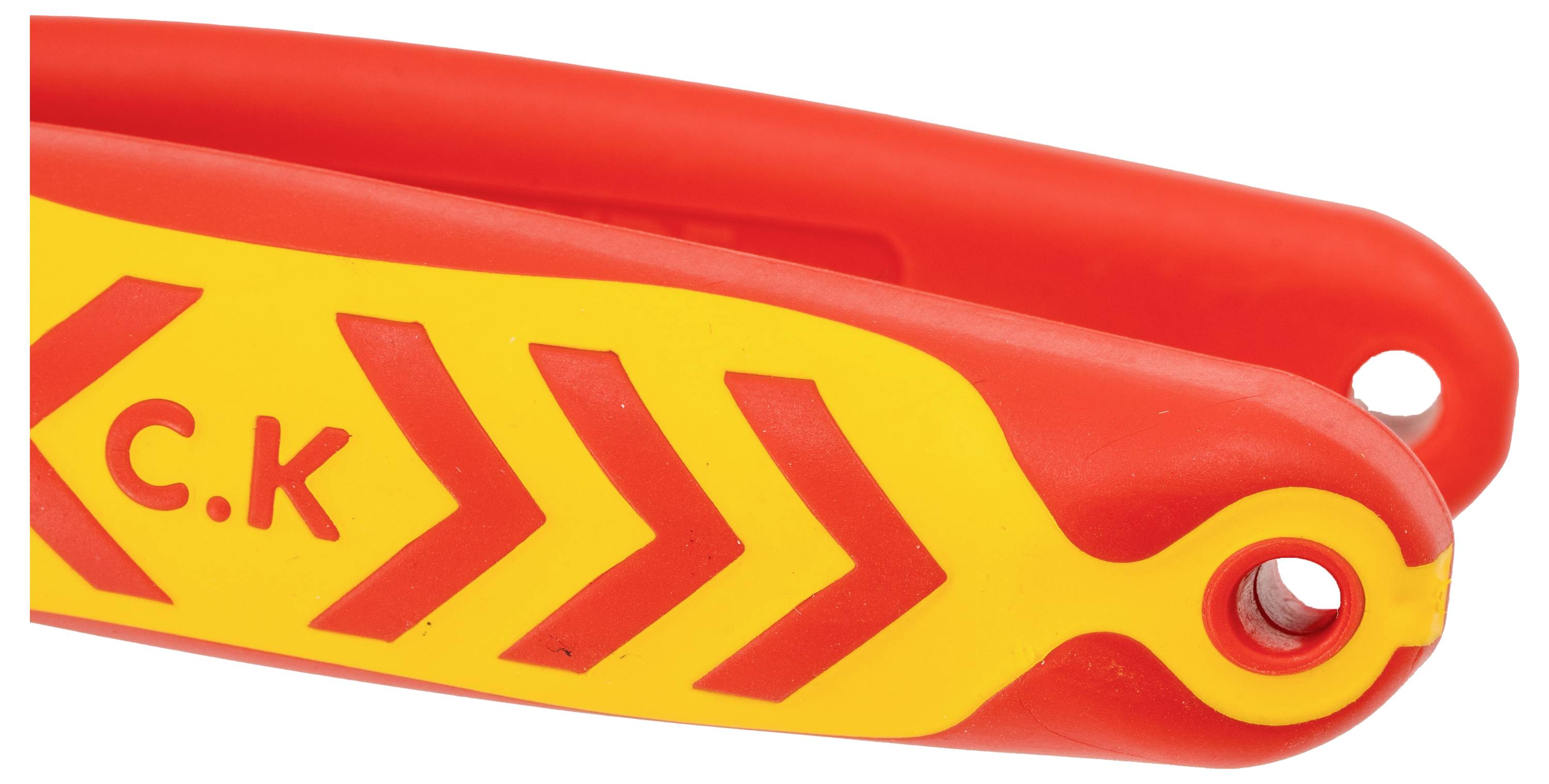 A close-up of a red and yellow tool handle with a chevron pattern and the initials 'C.K' printed on it.