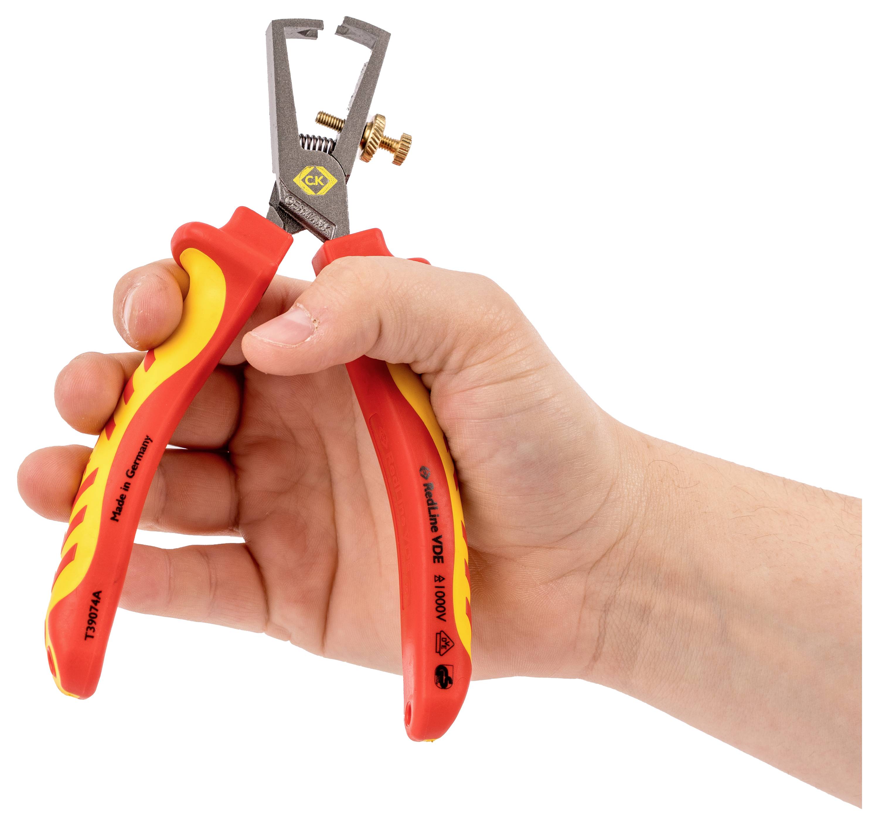 A hand holding red and yellow insulated wire strippers with an open jaw, ready to strip electrical wires; safety and tool details visible.