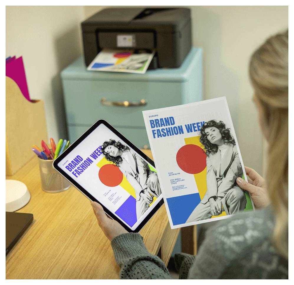 A person holds a tablet and a printed magazine titled 'Brand Fashion Week' featuring a black-and-white portrait and colorful shapes.