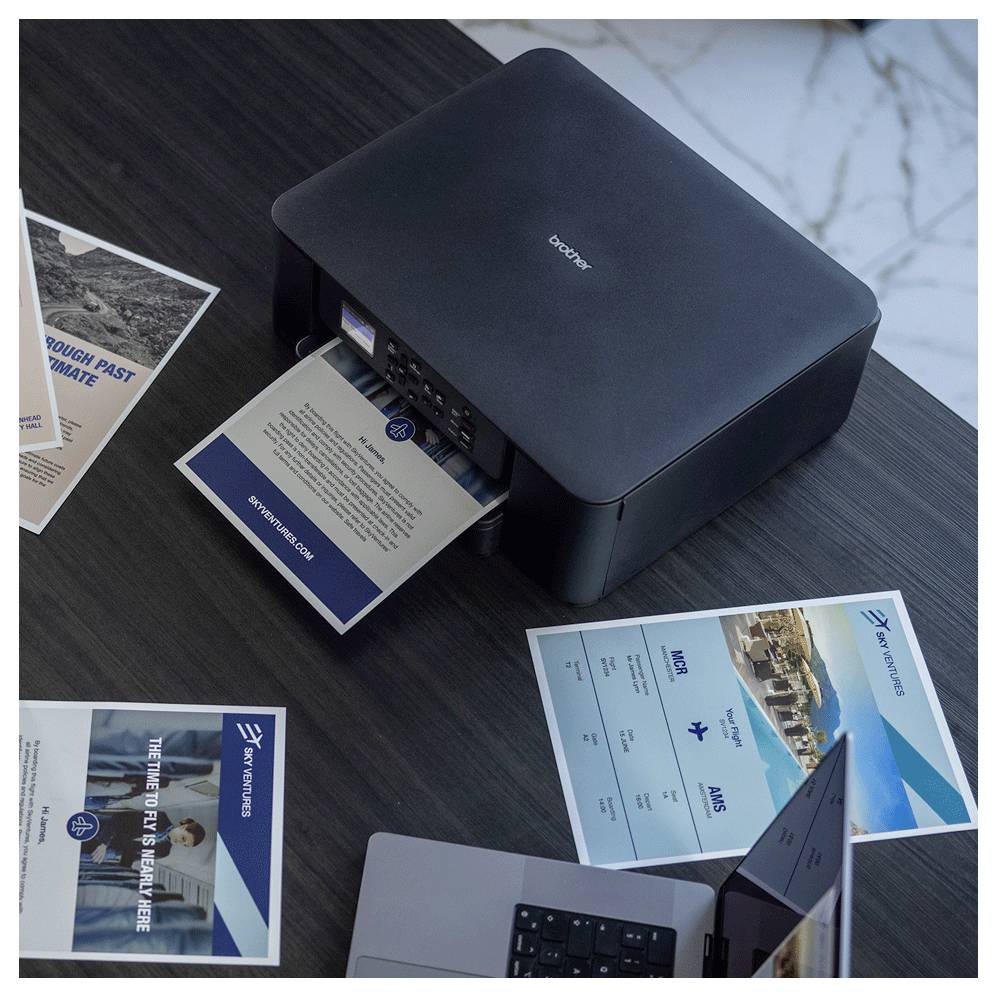 A black printer is actively printing a sheet with the title 'Future Growth Opportunities'. Nearby are brochures and a laptop.