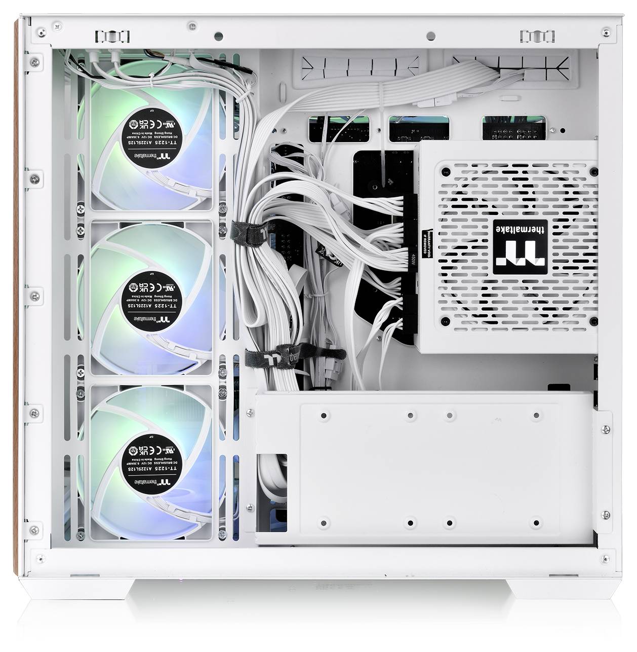 A white computer case with three front fans, glowing with blue and green lights, and neatly arranged internal cables and components.