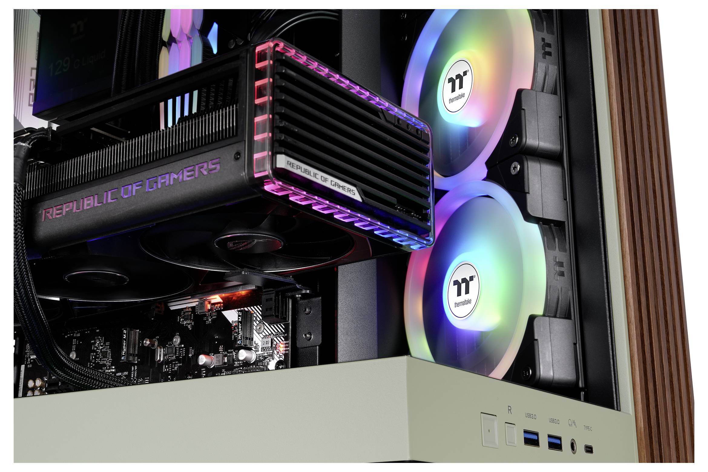 A gaming computer interior with a Republic of Gamers graphics card and colorful LED-lit cooling fans.