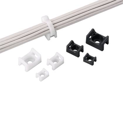 Cable clips in black and white of varying sizes next to bundled cables, demonstrating secure organization and color options.
