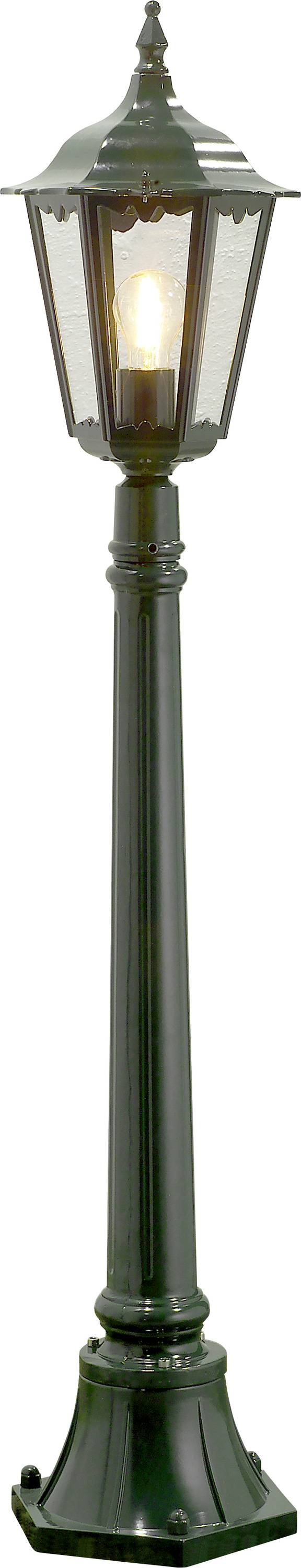 A black vintage-style street lamp with a glowing light bulb inside, featuring a tall, slender post and a decorative lantern top.