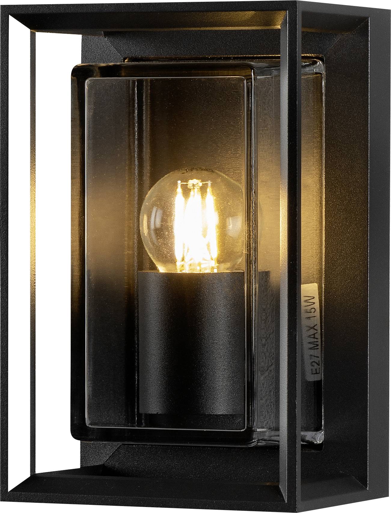 A black rectangular wall sconce with a lit bulb inside, casting a warm glow through a clear glass panel, designed for modern decor.
