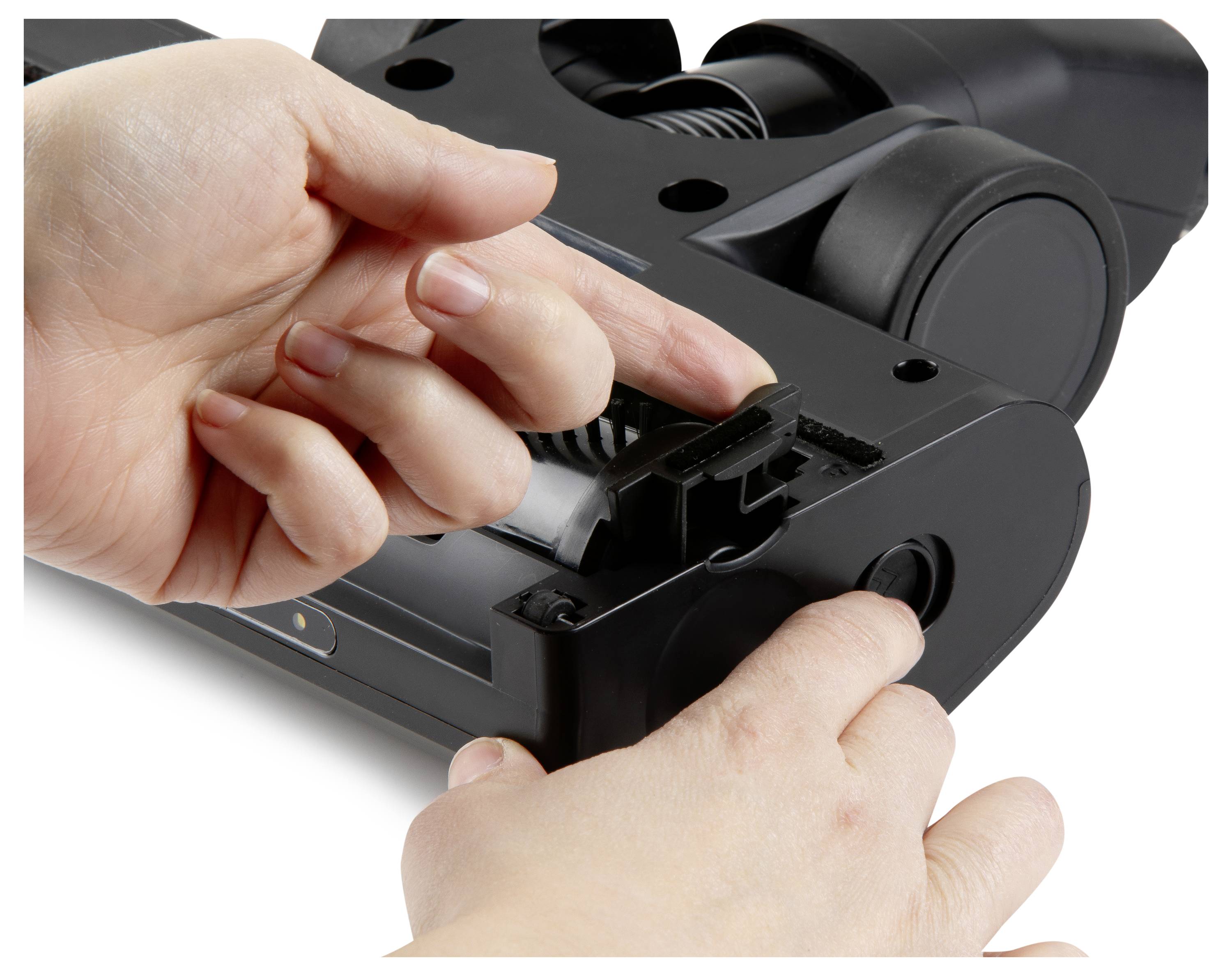 A person demonstrates how to open a vacuum cleaner brush head with two hands, highlighting maintenance or cleaning access.