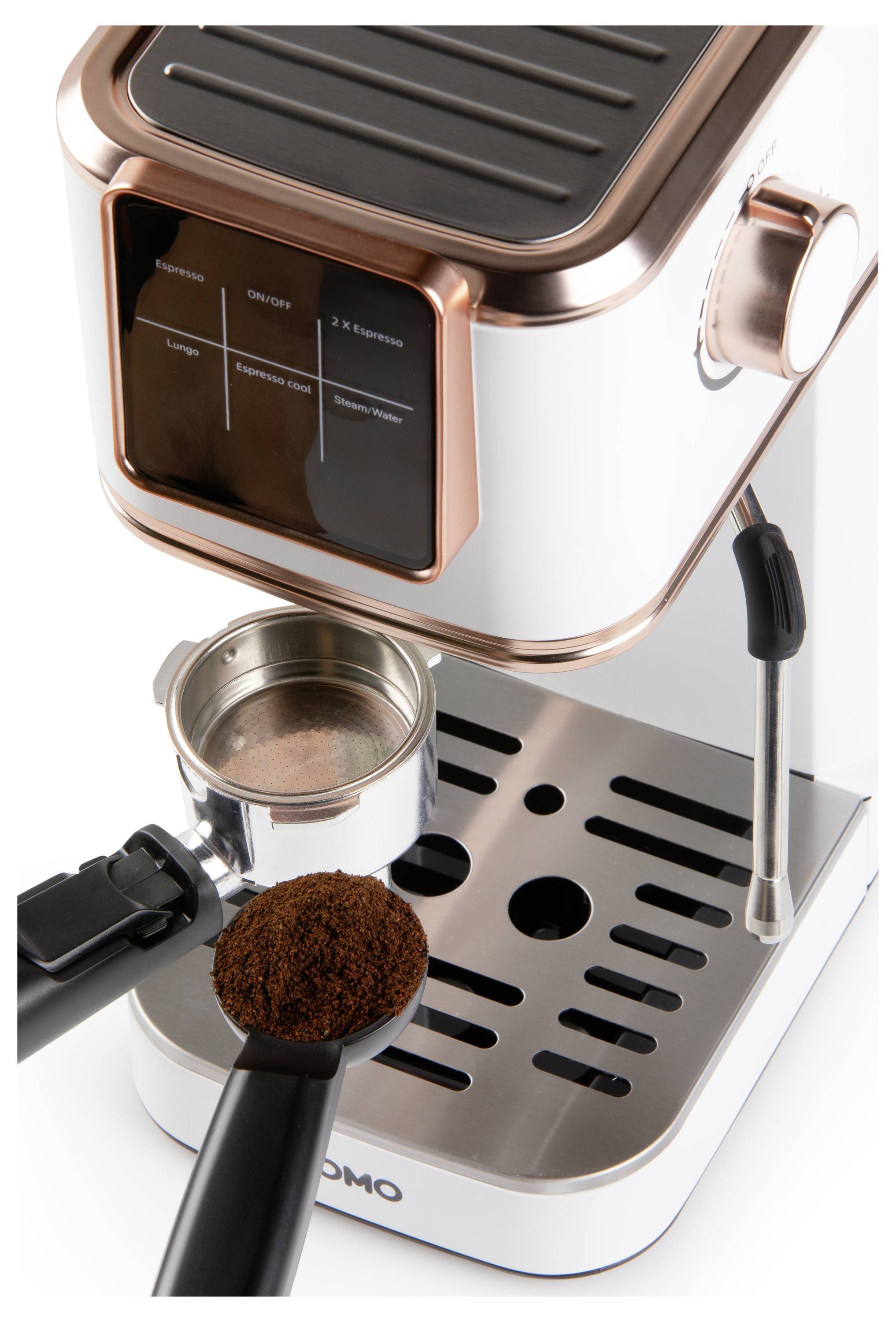 Espresso machine with copper accents, showing a portafilter and a scoop of ground coffee, placed on a metal drip tray.