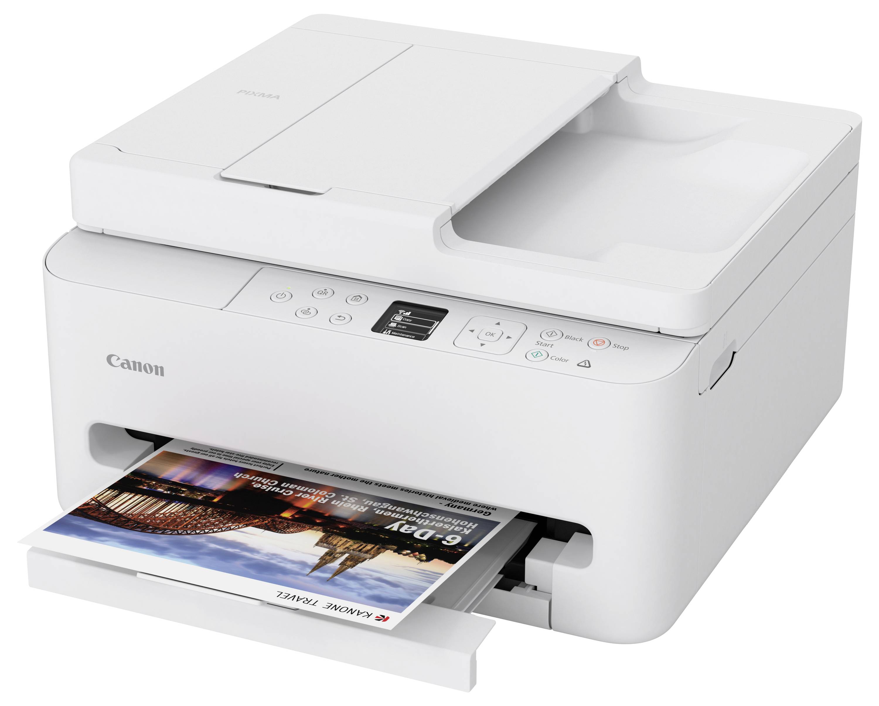 A white Canon multifunction printer with a document feeder, displaying a color print of a cityscape partially emerging from the output tray.