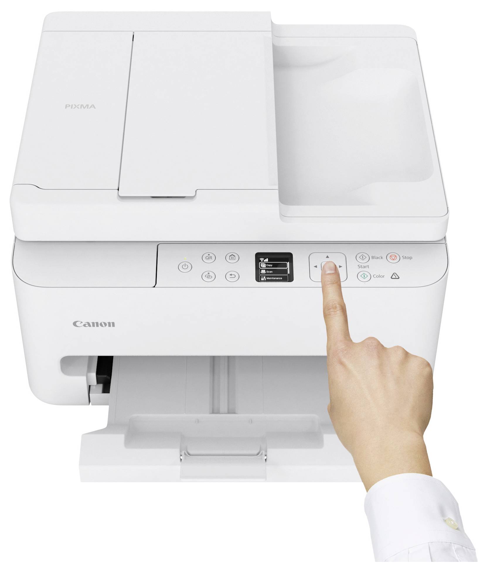 A person's hand pressing the power button on a Canon printer.