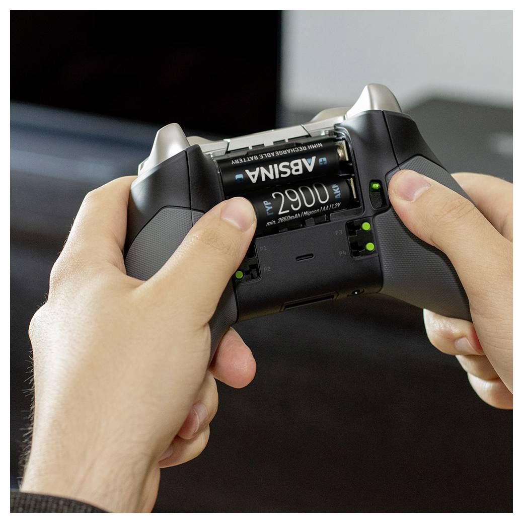Hands hold a gaming controller with a visible battery compartment showing 'AOSINA' batteries inside.