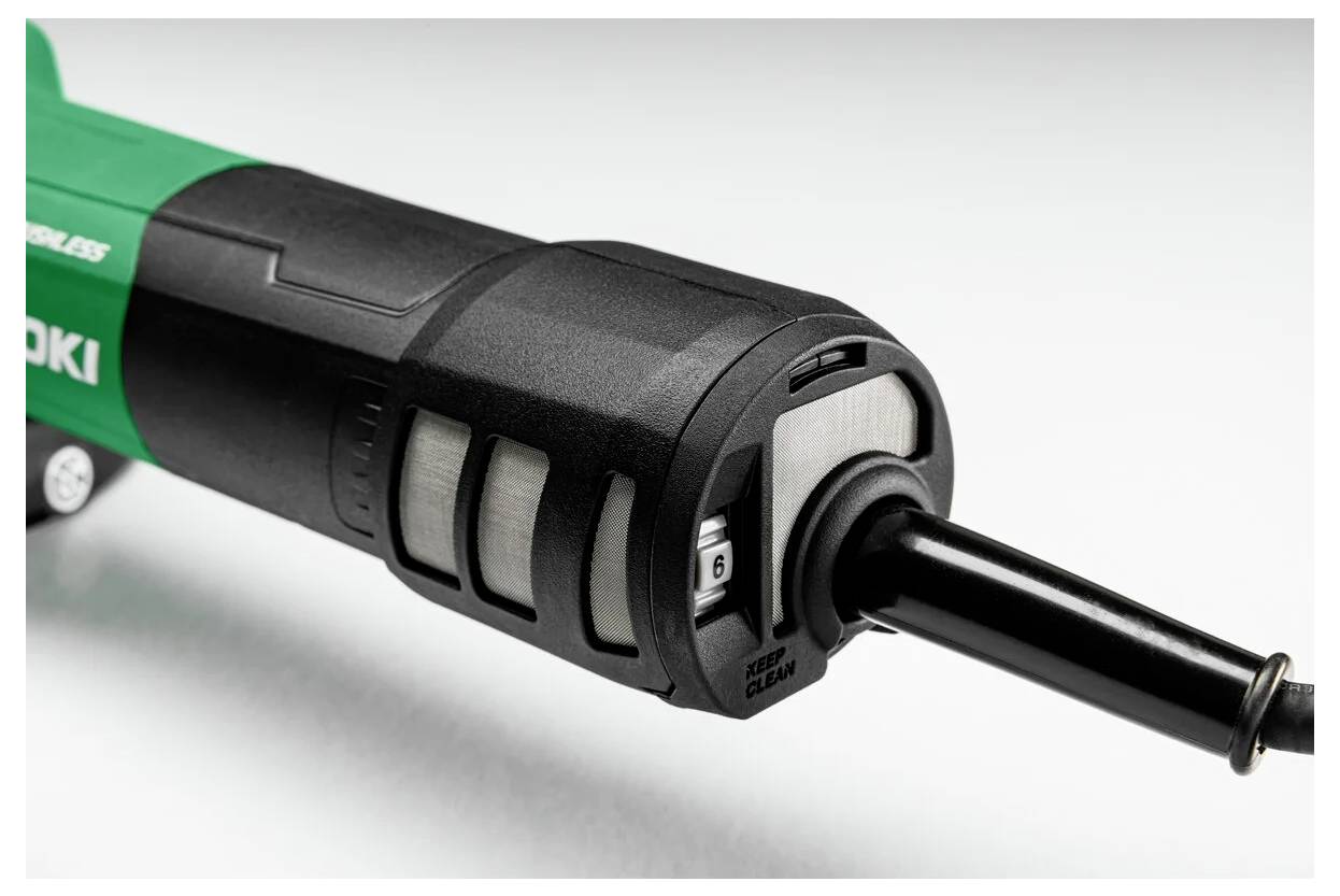 Close-up of a black and green cordless power tool with an adjustable dial displaying the number '6' for precision settings.