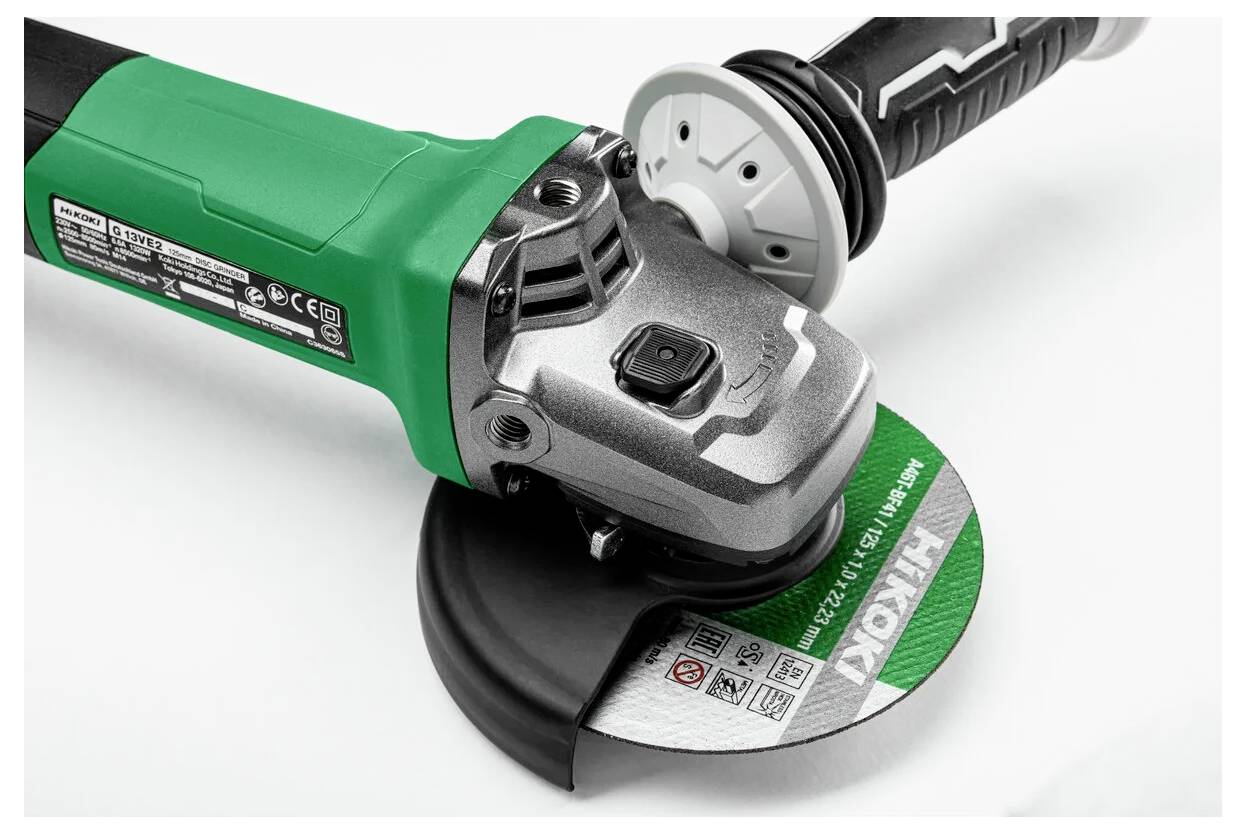 A green and silver power tool with a circular cutting blade, used for grinding, cutting, and polishing materials.