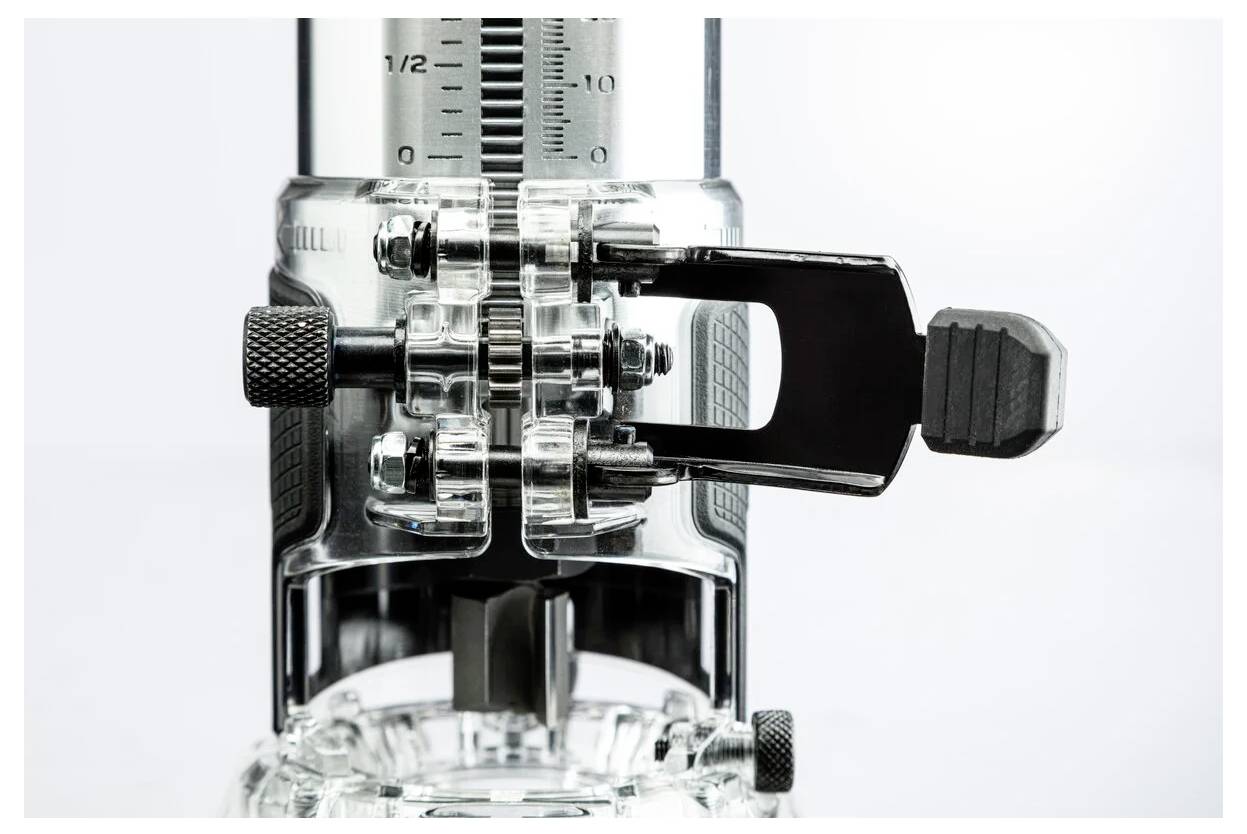 A close-up of a metal and plastic mechanical tool with a ruler and adjustment knobs, used for precision measurements or adjustments.