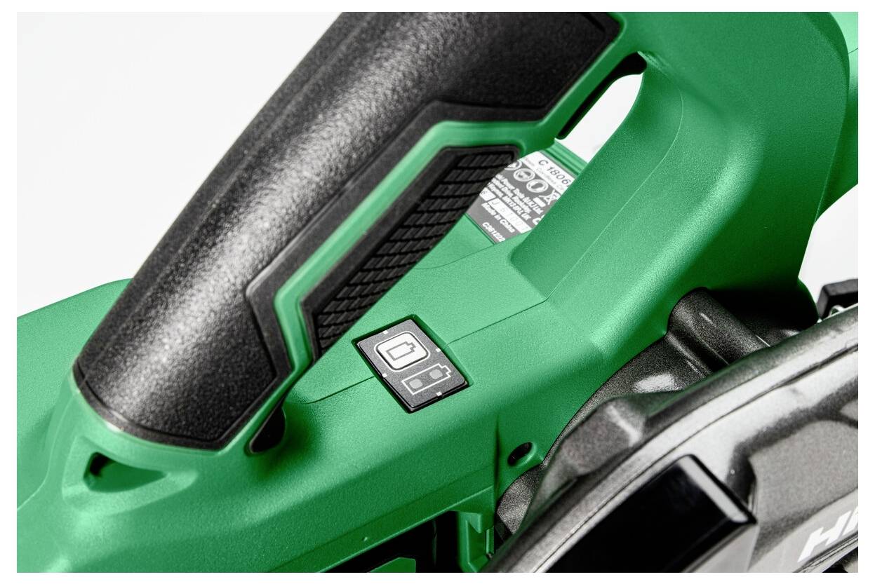 Close-up of a green power tool handle featuring a black grip texture and a visible power button, highlighting design details.