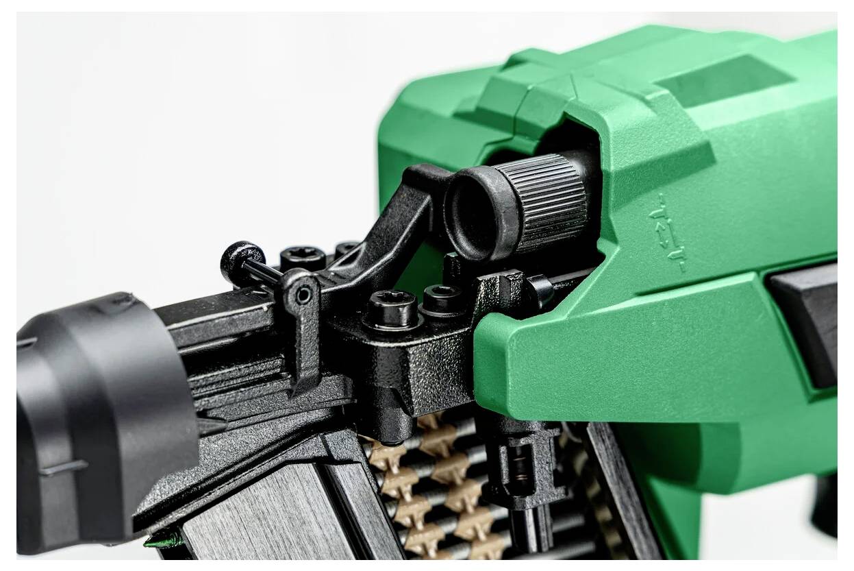Close-up of a green and black power tool, showing the adjustable mechanism and textured components, likely for industrial or construction use.