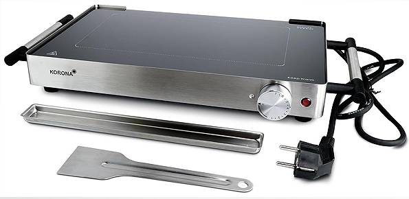 'Korona' electric griddle with heat control knob, power plug, and include spatula and drip tray for cooking.