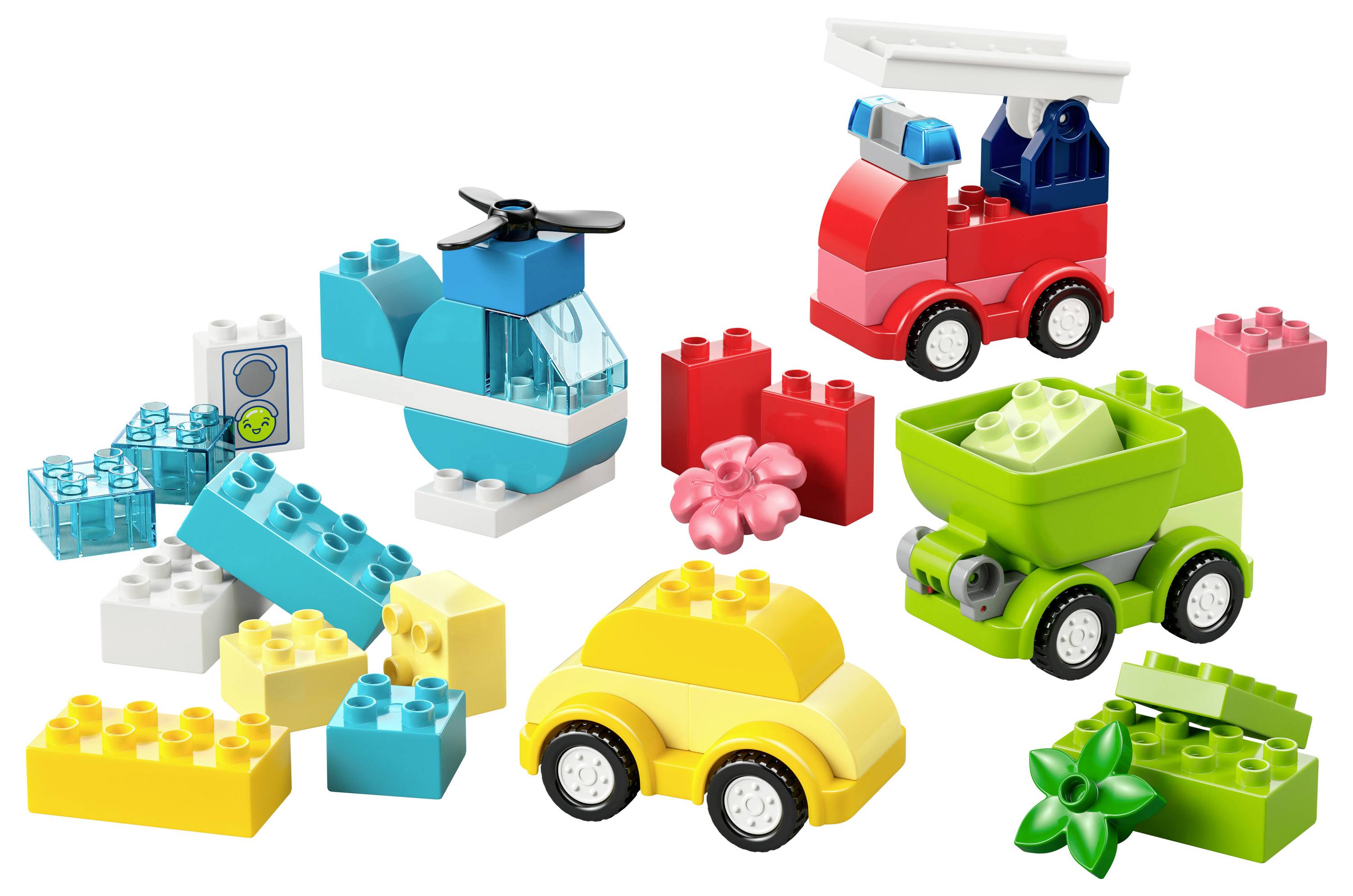 A collection of colorful toy building blocks forming a helicopter, a fire truck, and a car, alongside various loose blocks.