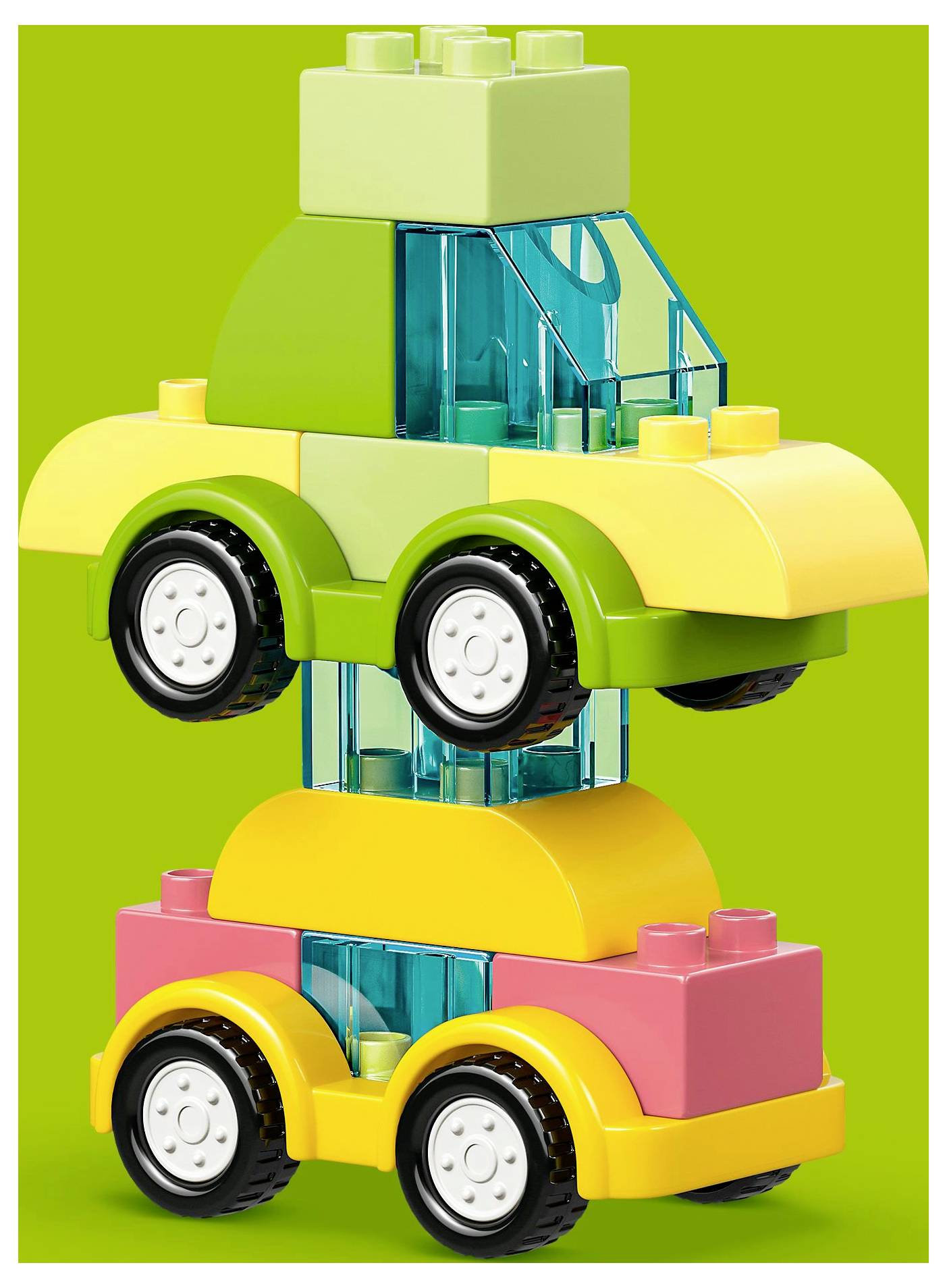 Two colorful toy cars stacked vertically; green car on top of pink car, both with vibrant blocks and wheels. Bright green background.