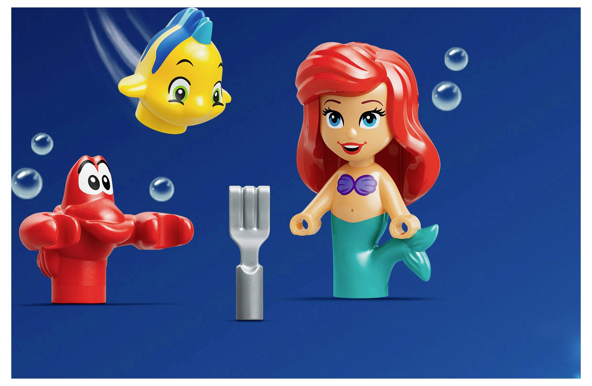 LEGO figures depicting a mermaid, crab, and fish, with a gray fork shown as an underwater object.