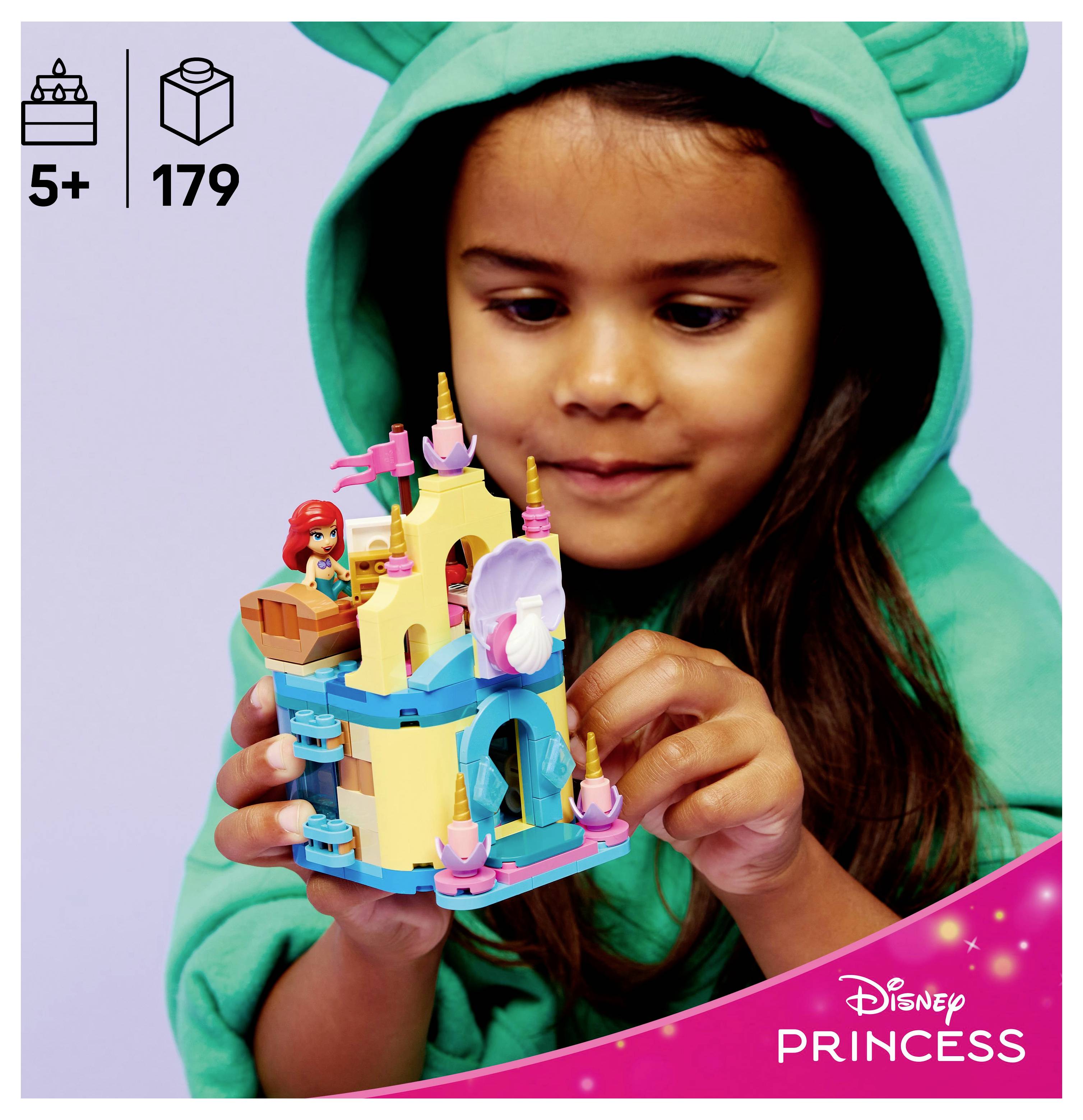 A child in a green hoodie plays with a Disney Princess LEGO set featuring an Ariel figure and castle, suitable for ages 5 and up, 179 pieces.