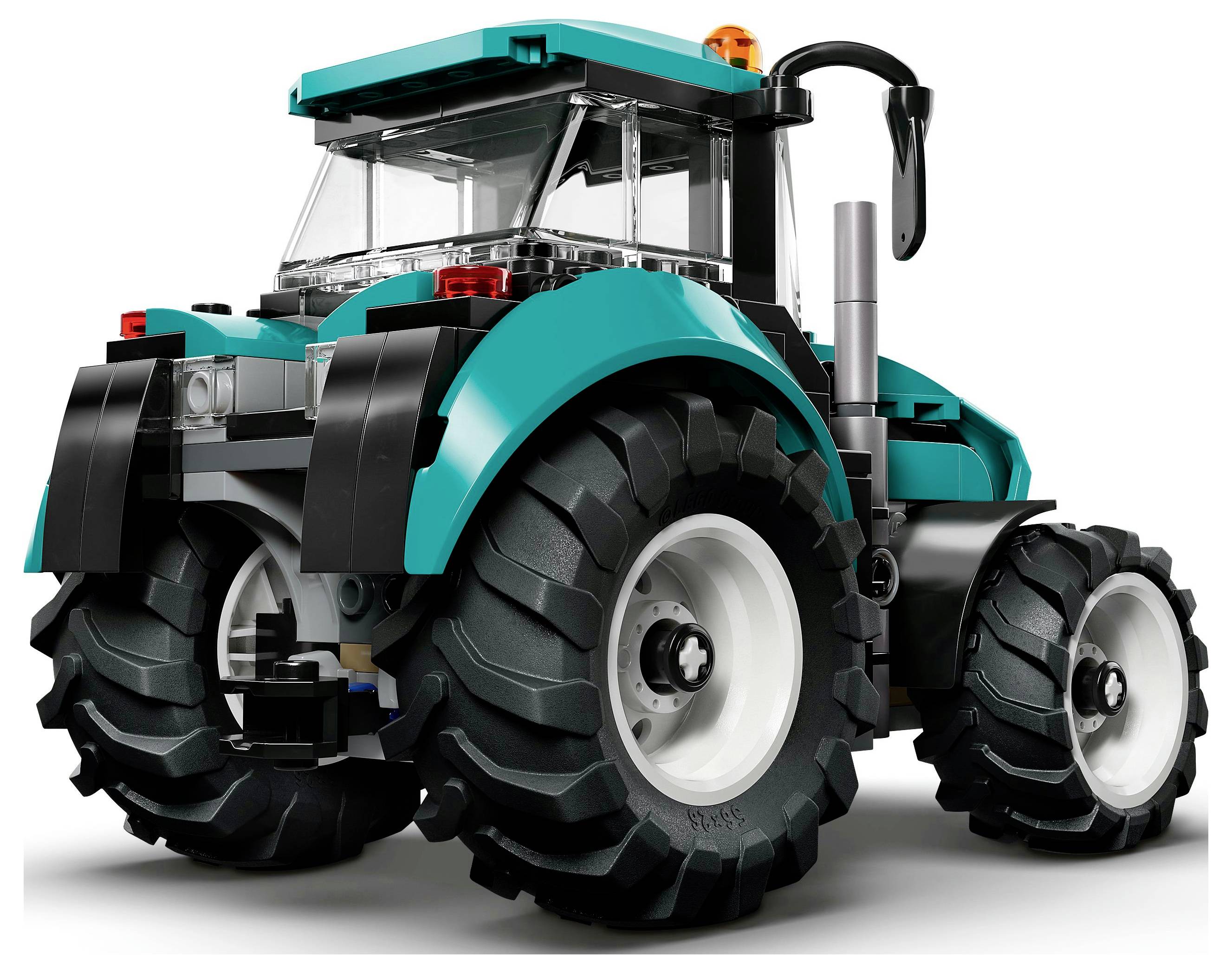 A teal and black LEGO tractor model with large rear wheels, visible exhaust pipe, and a clear cab, viewed from the rear-left angle.