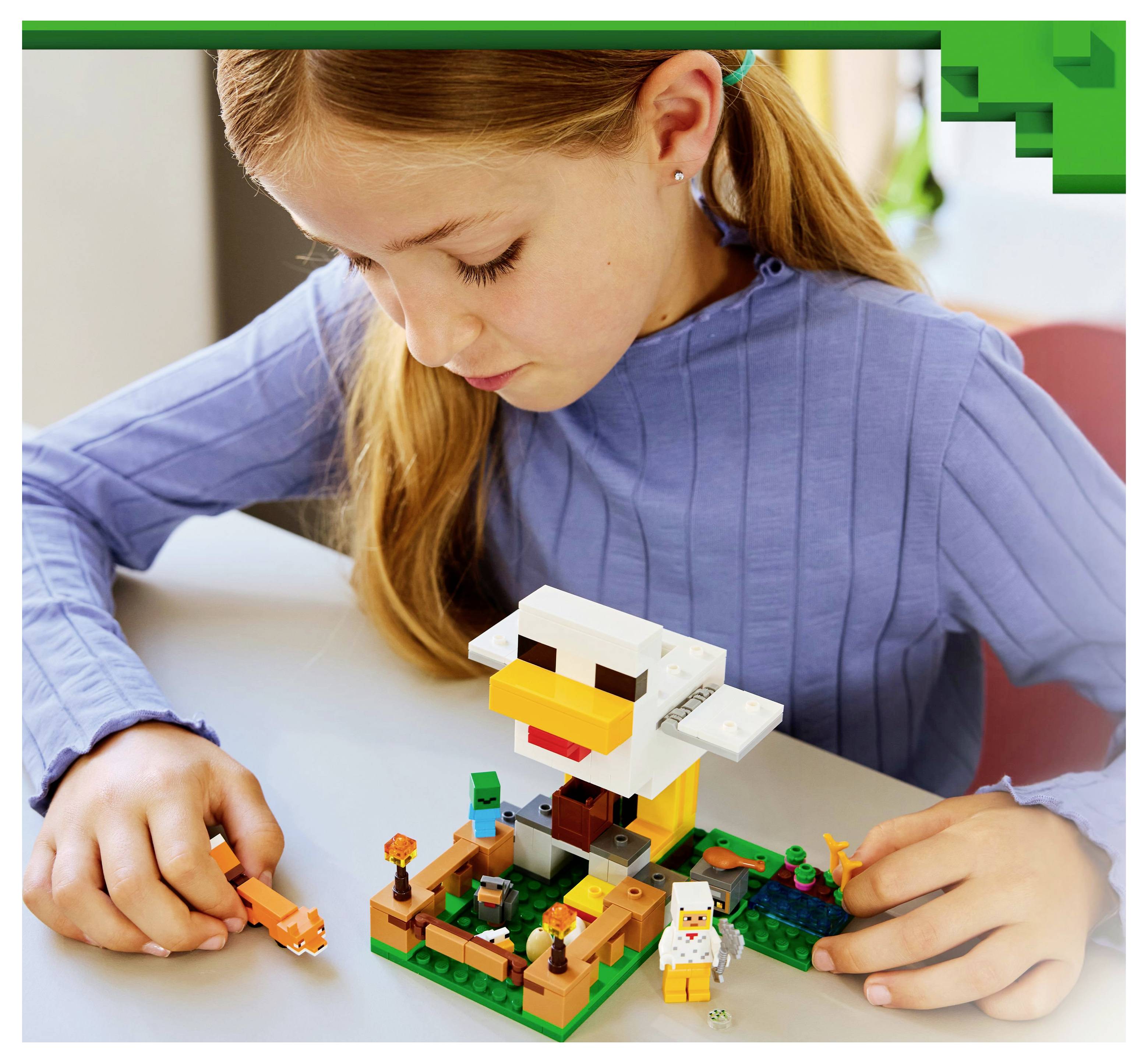 A child in a blue shirt plays with a toy set that includes a block structure resembling a duck and figures on a table.