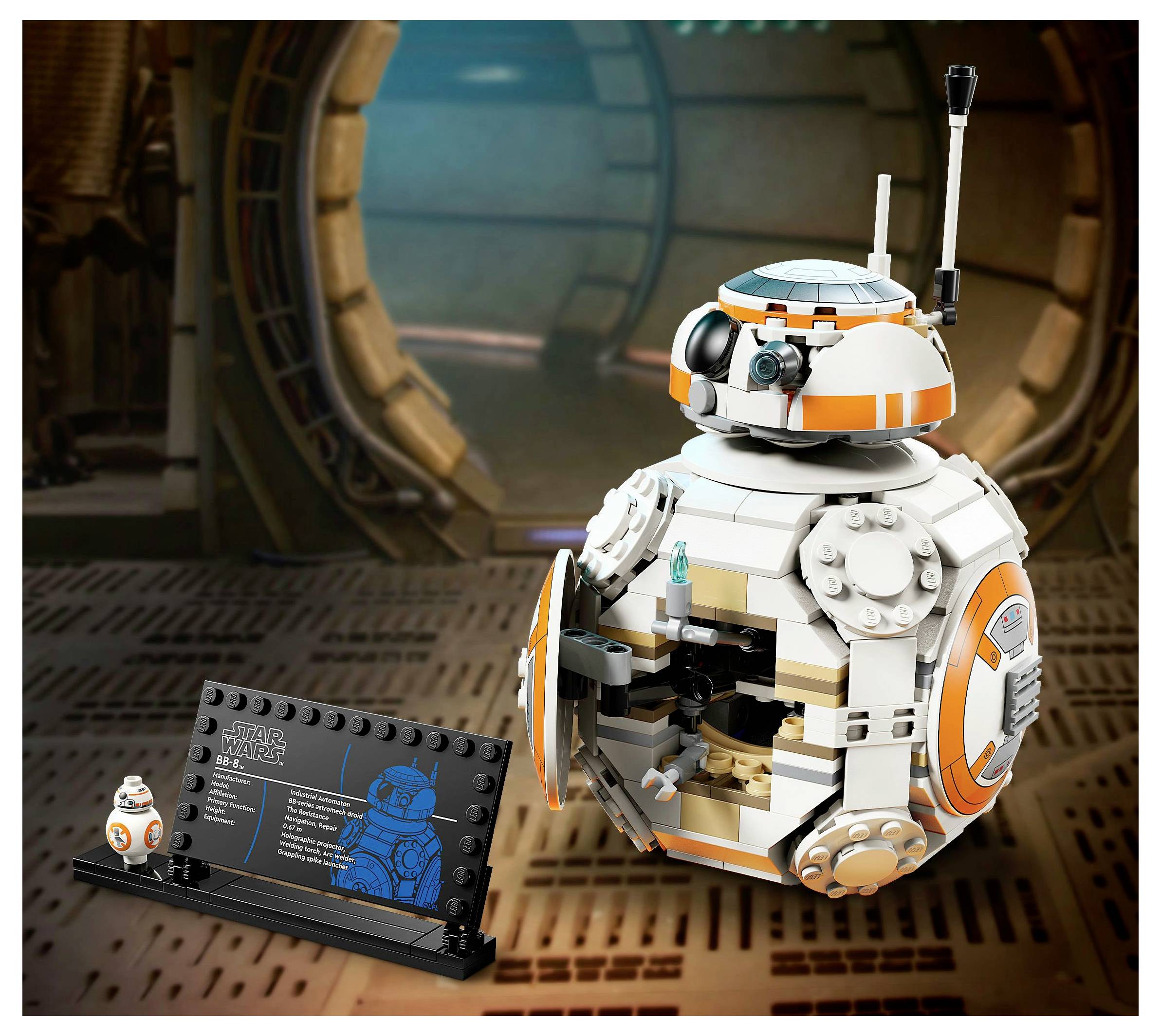A model of a spherical droid with a small antenna and orange accents is open to reveal internal components, next to a display plaque.