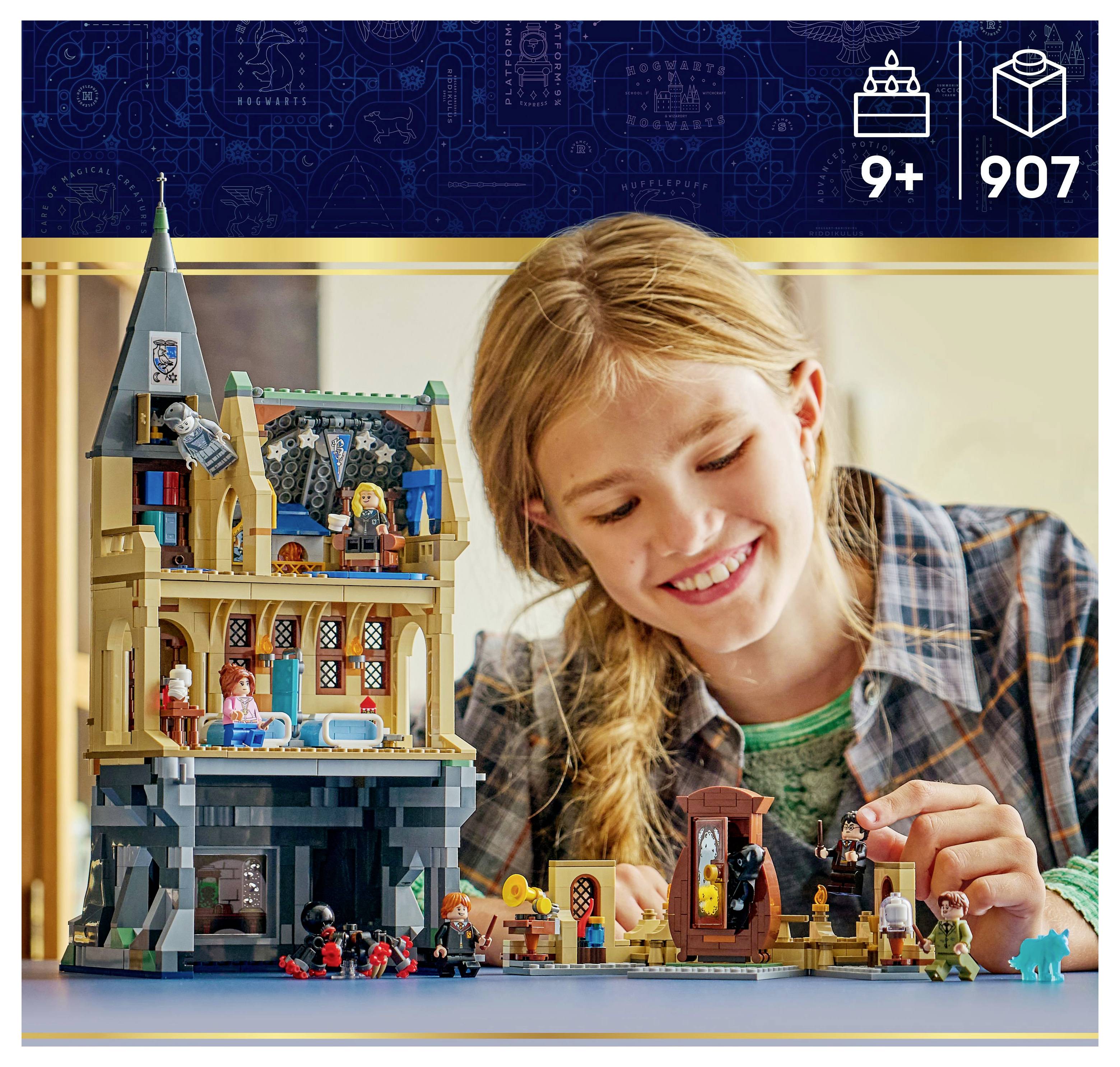 A child joyfully assembles a multi-story building toy set with various characters on a table. The set is designed for ages 9+ and contains 907 pieces.