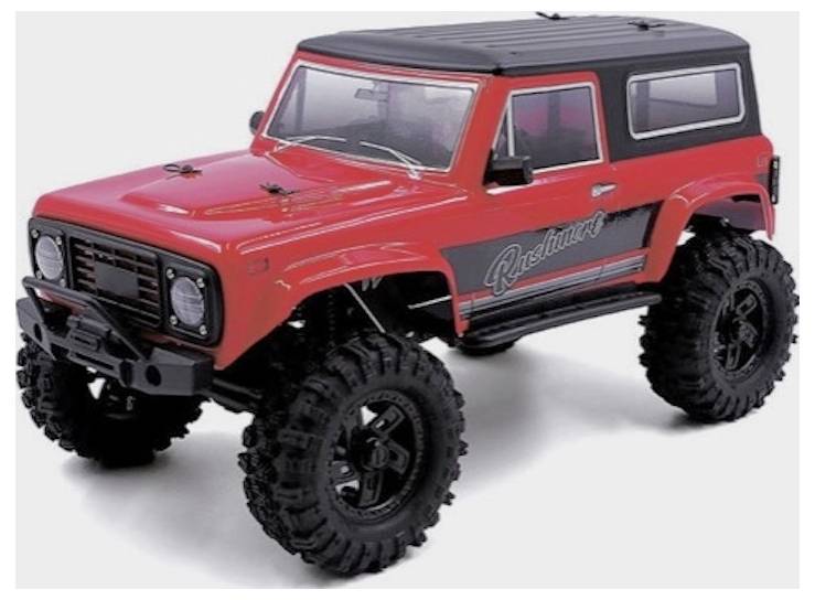 A red remote-controlled off-road vehicle with large textured tires and a black roof.