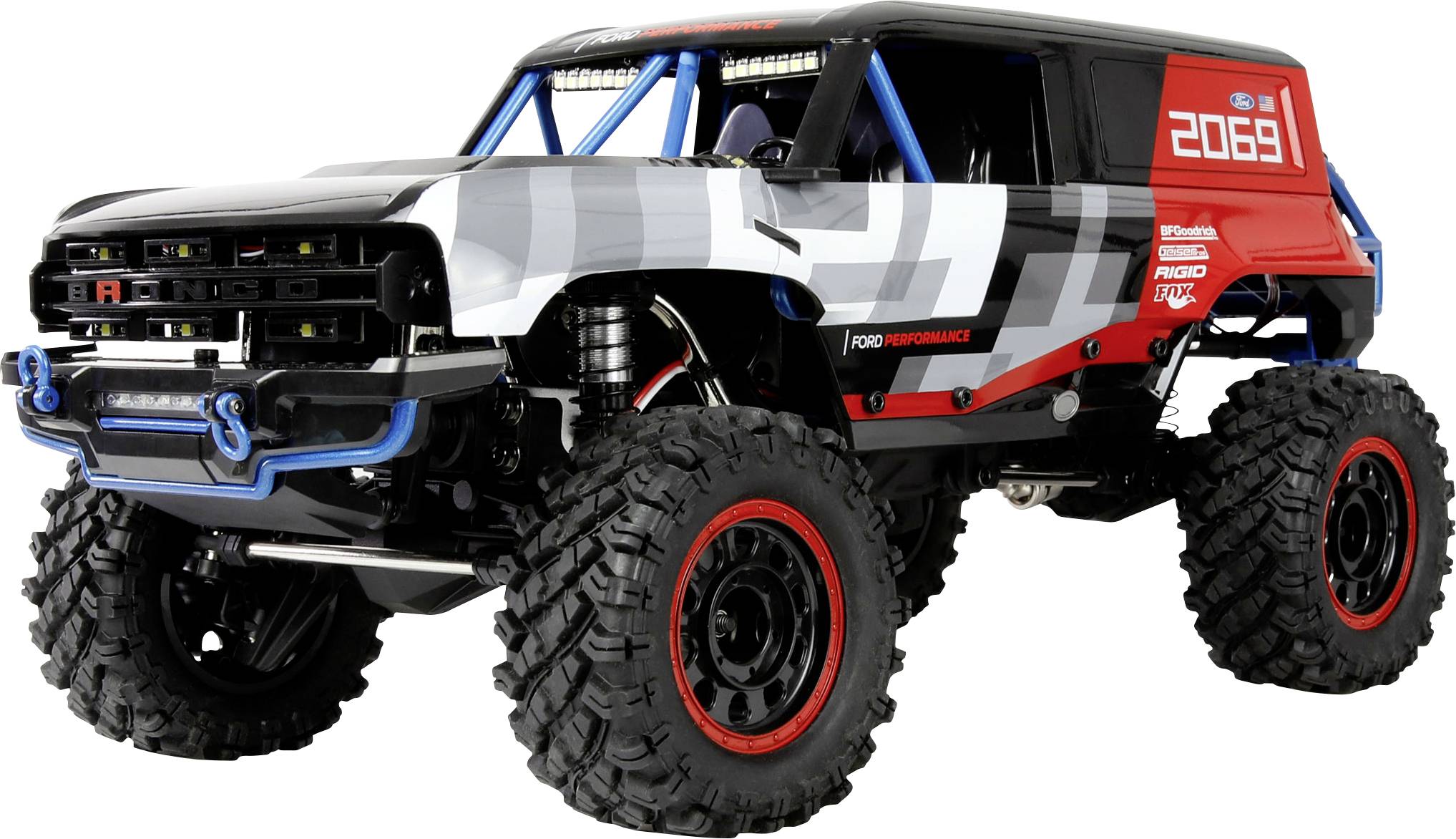 A large-scale, off-road RC (remote control) truck with oversized tires and a white, black, and red body, emphasizing rugged design.