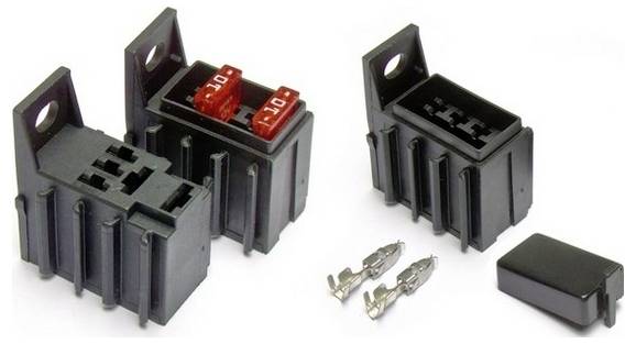 Automotive fuse holders and connectors with two red fuses inserted, paired with metal terminals and a black cover on the side.