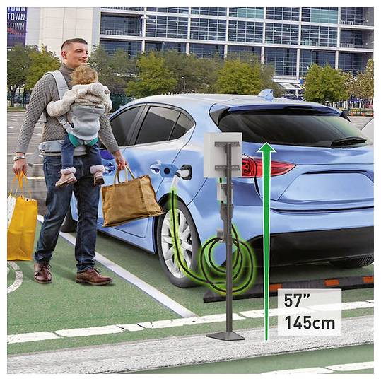 A father with a child in a carrier stands next to a blue electric car charging at a station in a parking lot. Car height labeled '57