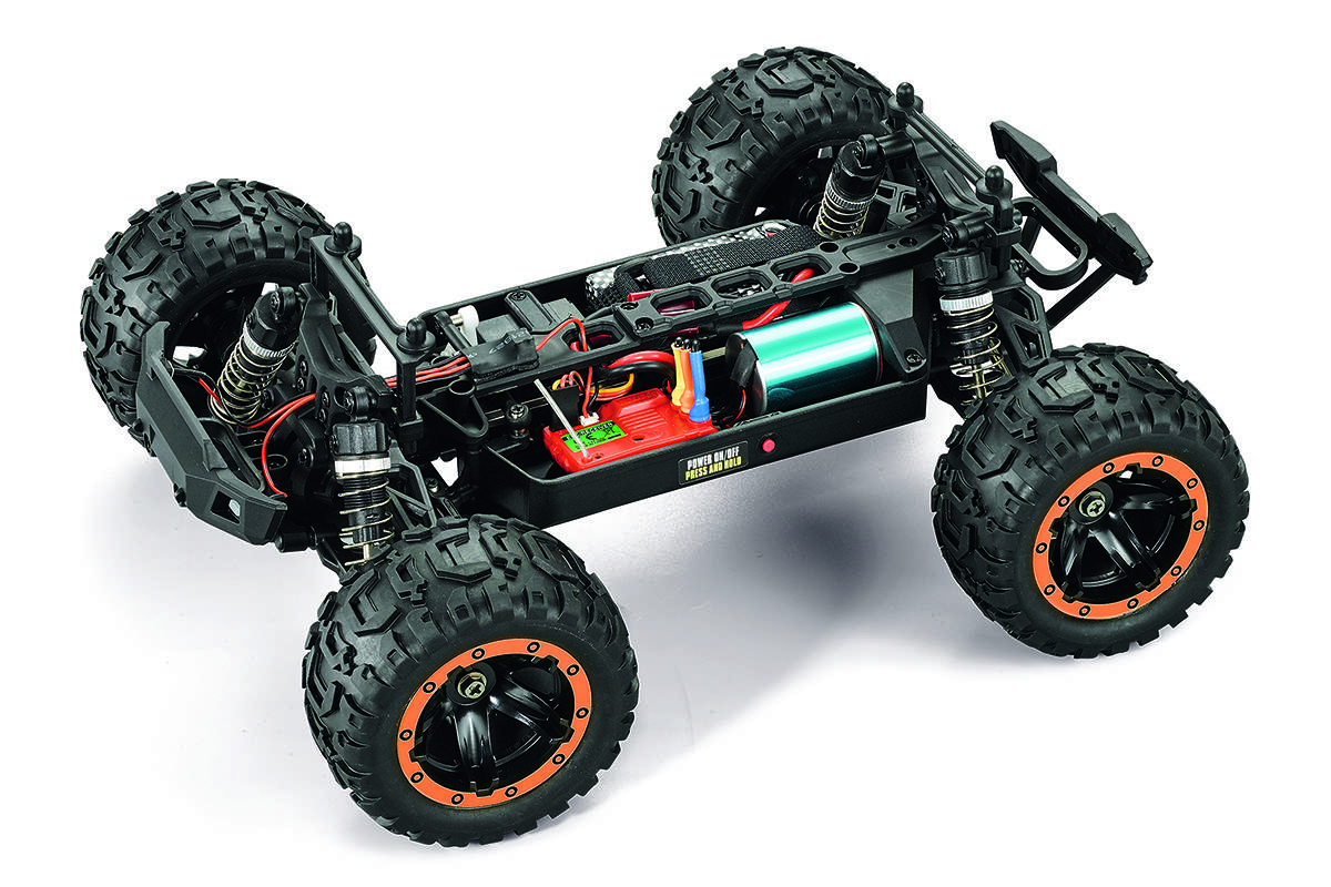 Remote-controlled off-road vehicle chassis showcasing large tires, suspension system, and a visible battery compartment.