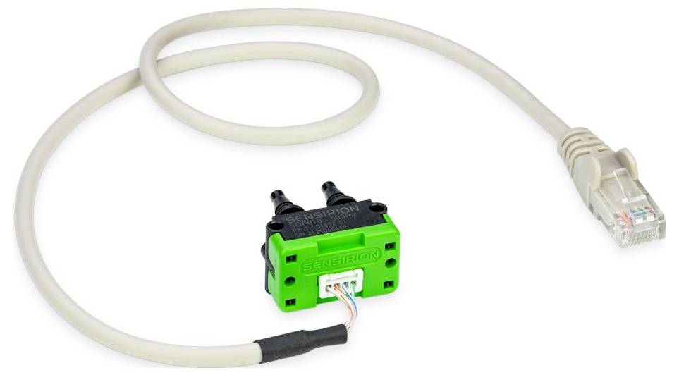 A green micro switch connected to a beige RJ45 cable, used in networking or electronic applications.