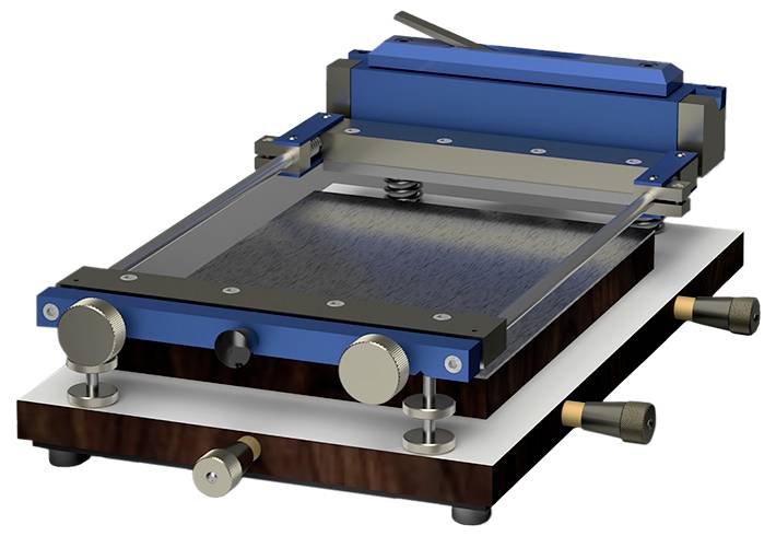 Image of a mechanical device with a blue frame and adjustable knobs, used for precise positioning or alignment of items on a flat surface.