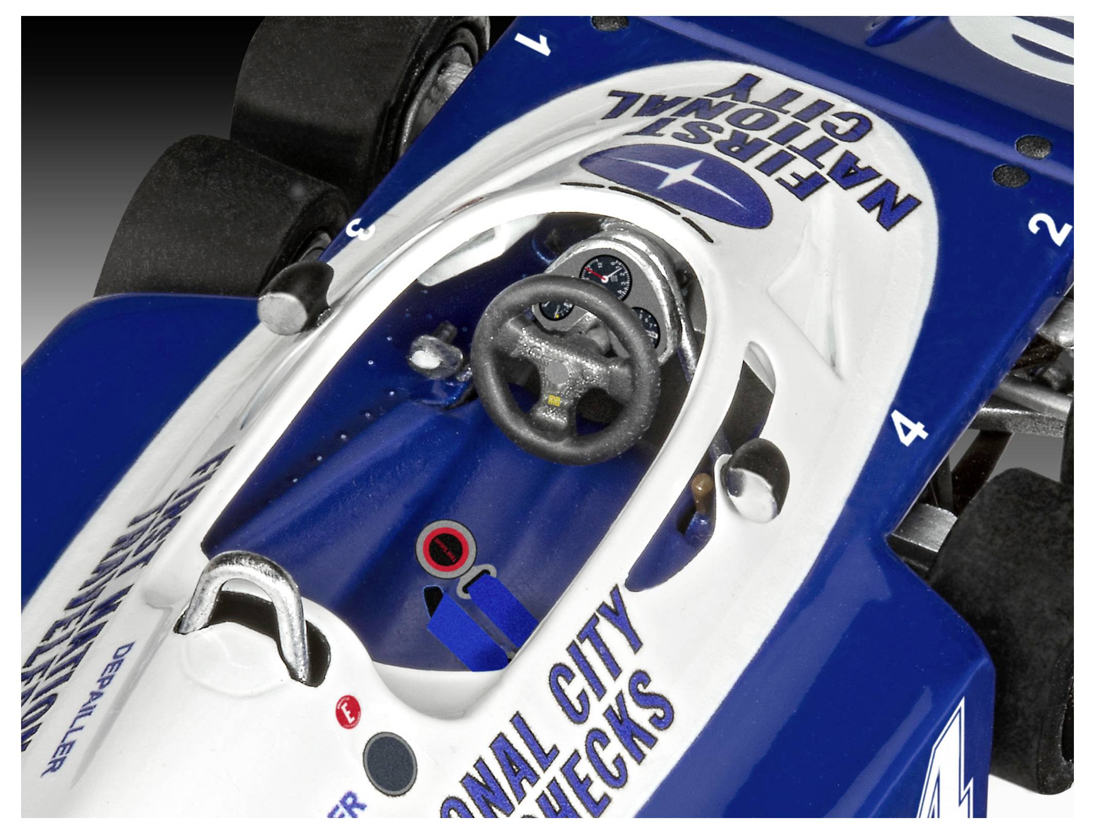 A close-up view of a blue and white Formula 1 race car cockpit, labeled 'First National City', showing the steering wheel and dashboard controls.