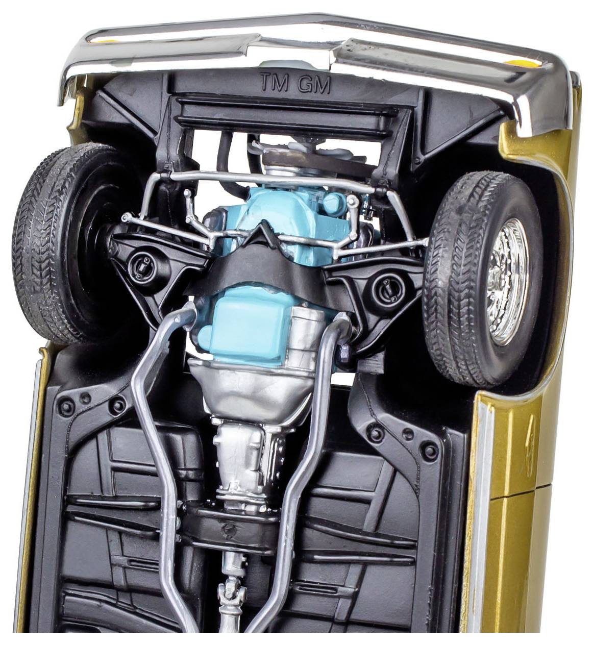 'Model car's underside showing detailed suspension, exhaust, and drivetrain components.'