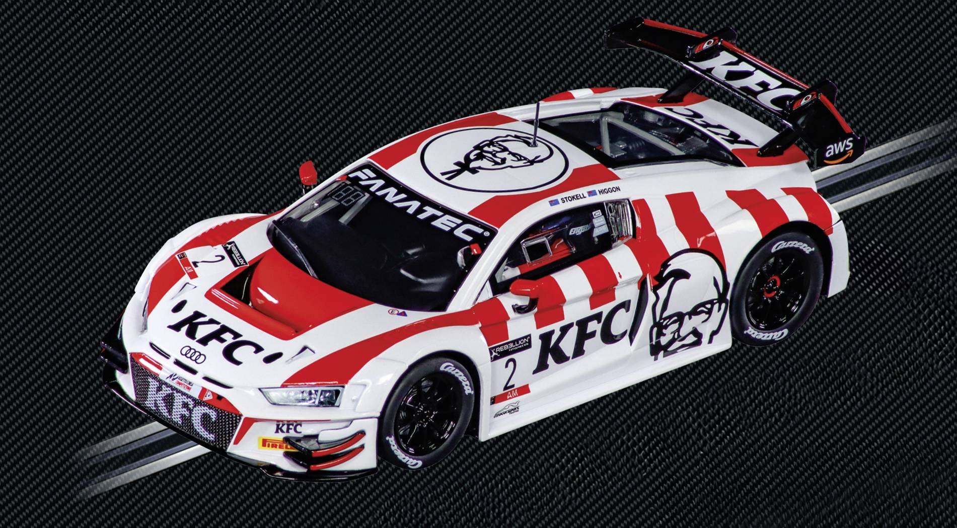 A race car with KFC branding and a red and white design, featuring the Colonel Sanders logo on the hood, racing on a track.