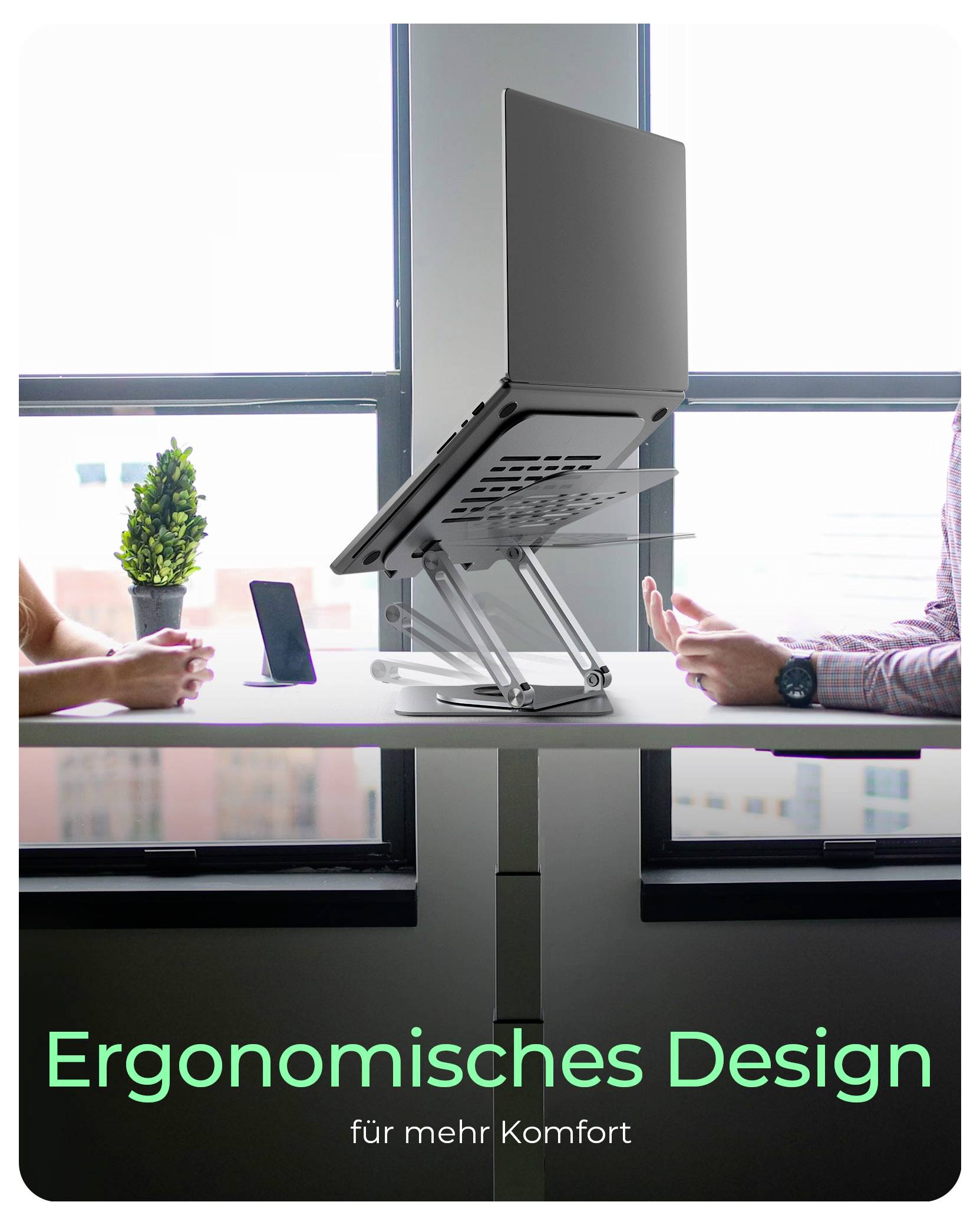 A laptop on a stand between two seated people at a desk, with the text 'Ergonomisches Design für mehr Komfort' highlighting ergonomic design.