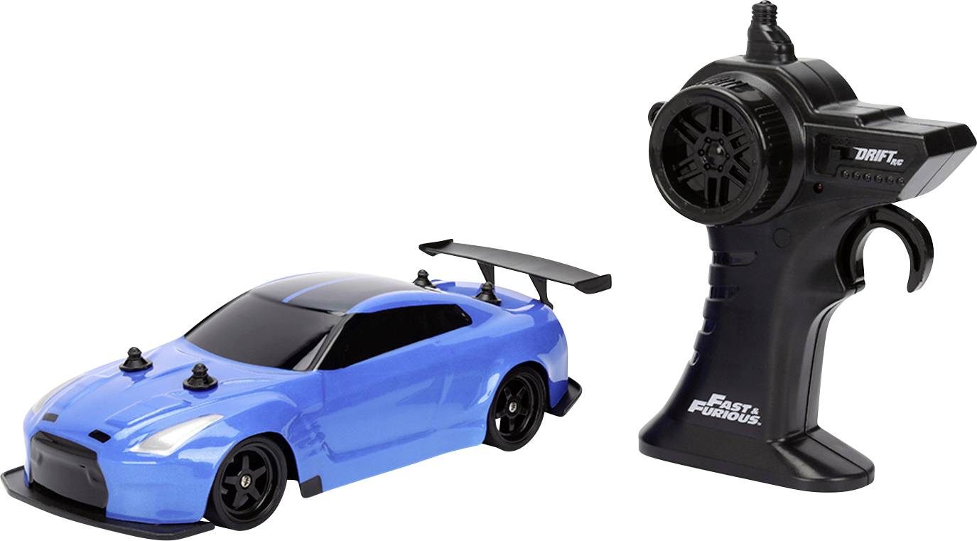 A blue remote-controlled car next to a black controller, featuring branding from 'Fast & Furious'.
