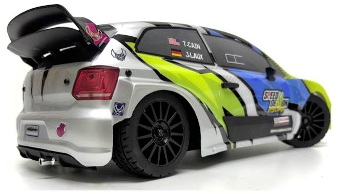 A colorful toy race car viewed from the rear left, featuring vibrant decals and sponsor logos, with large black wheels and a rear spoiler.