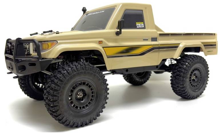 Tan off-road toy truck with large tires and black detailing on the body.