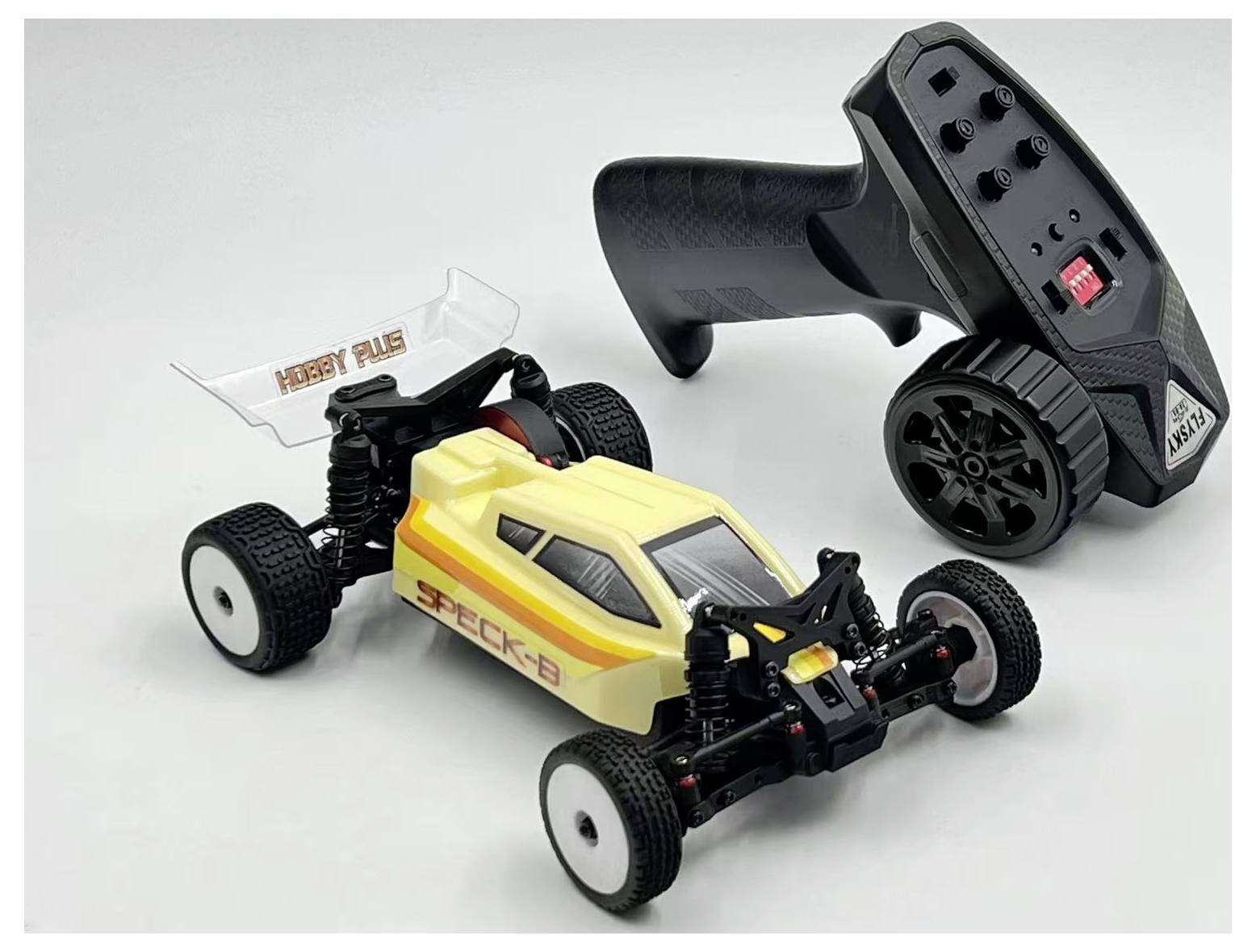 'A yellow and white remote-controlled car with a black radio controller beside it, featuring the brand name 'Hobby Plus'.'