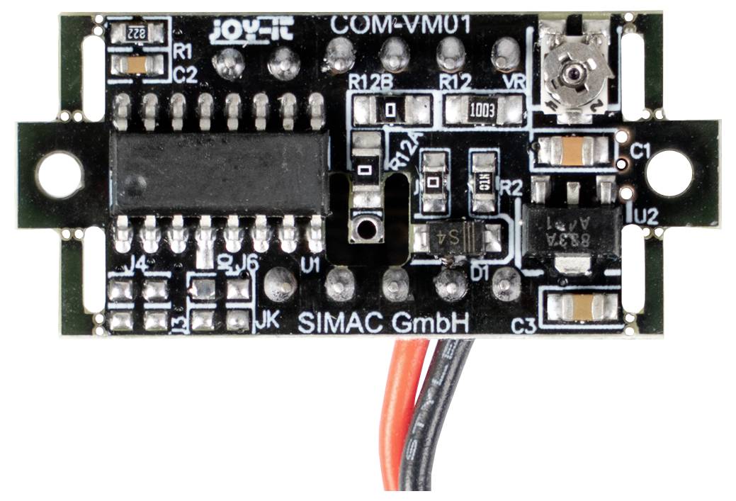 A small black circuit board with various electronic components, including resistors, capacitors, and a microchip. Two red and black wires extend from the bottom.