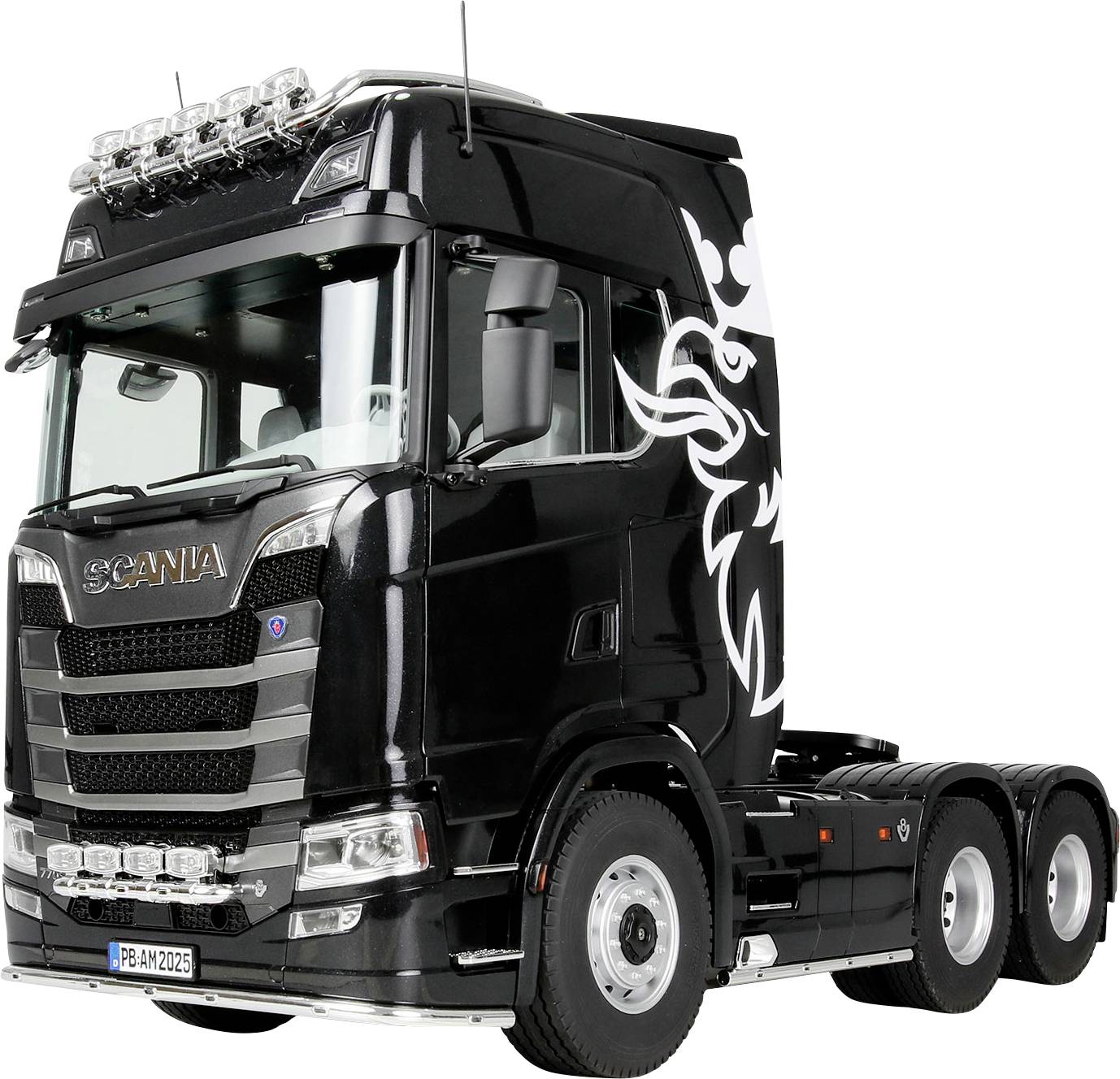 A black semi-truck cab with a decorative white design on the side, featuring silver details and multiple lights on top.