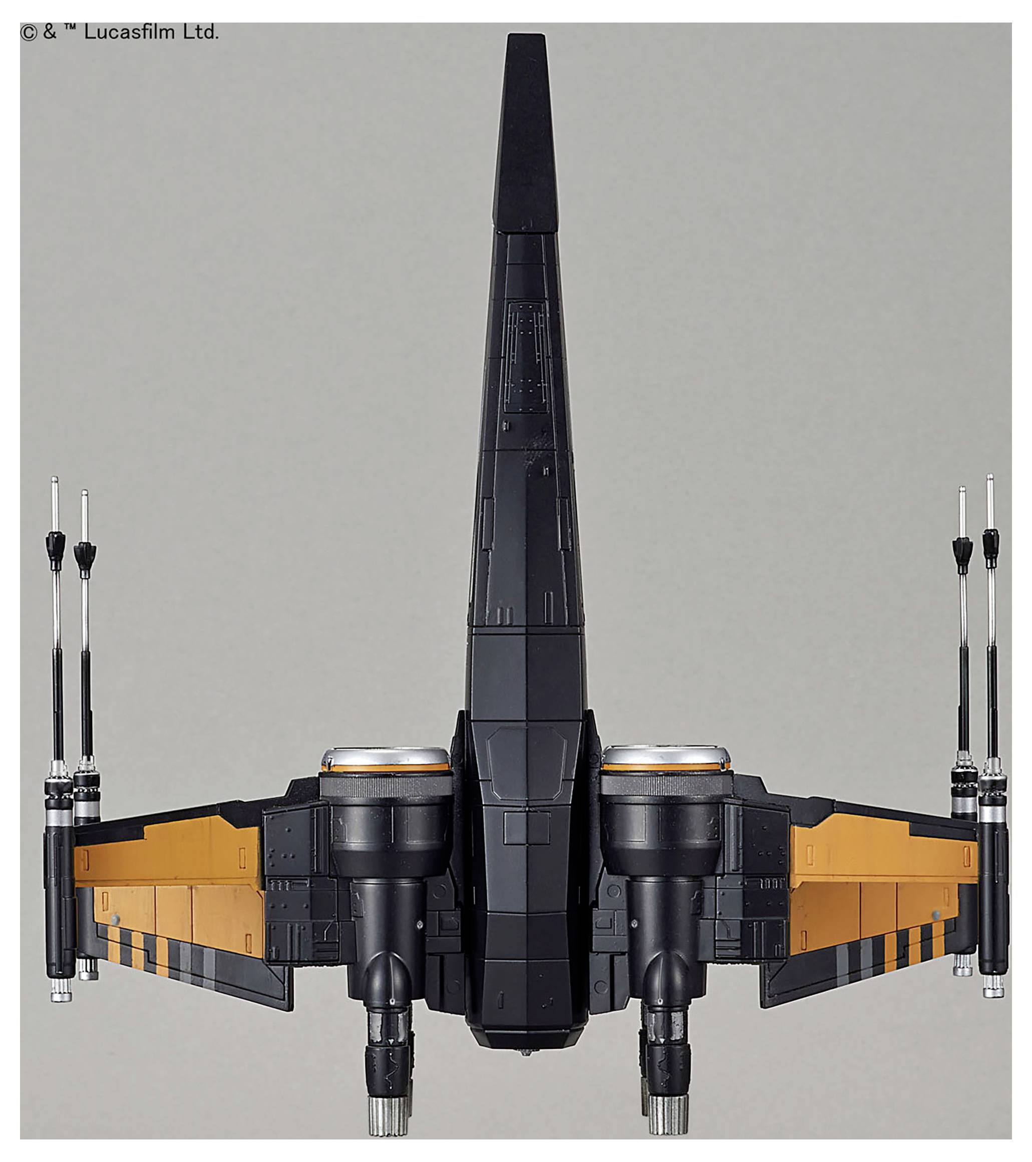 A toy model of a futuristic black and orange spacecraft with two engines and a vertical stabilizer, viewed from the rear.