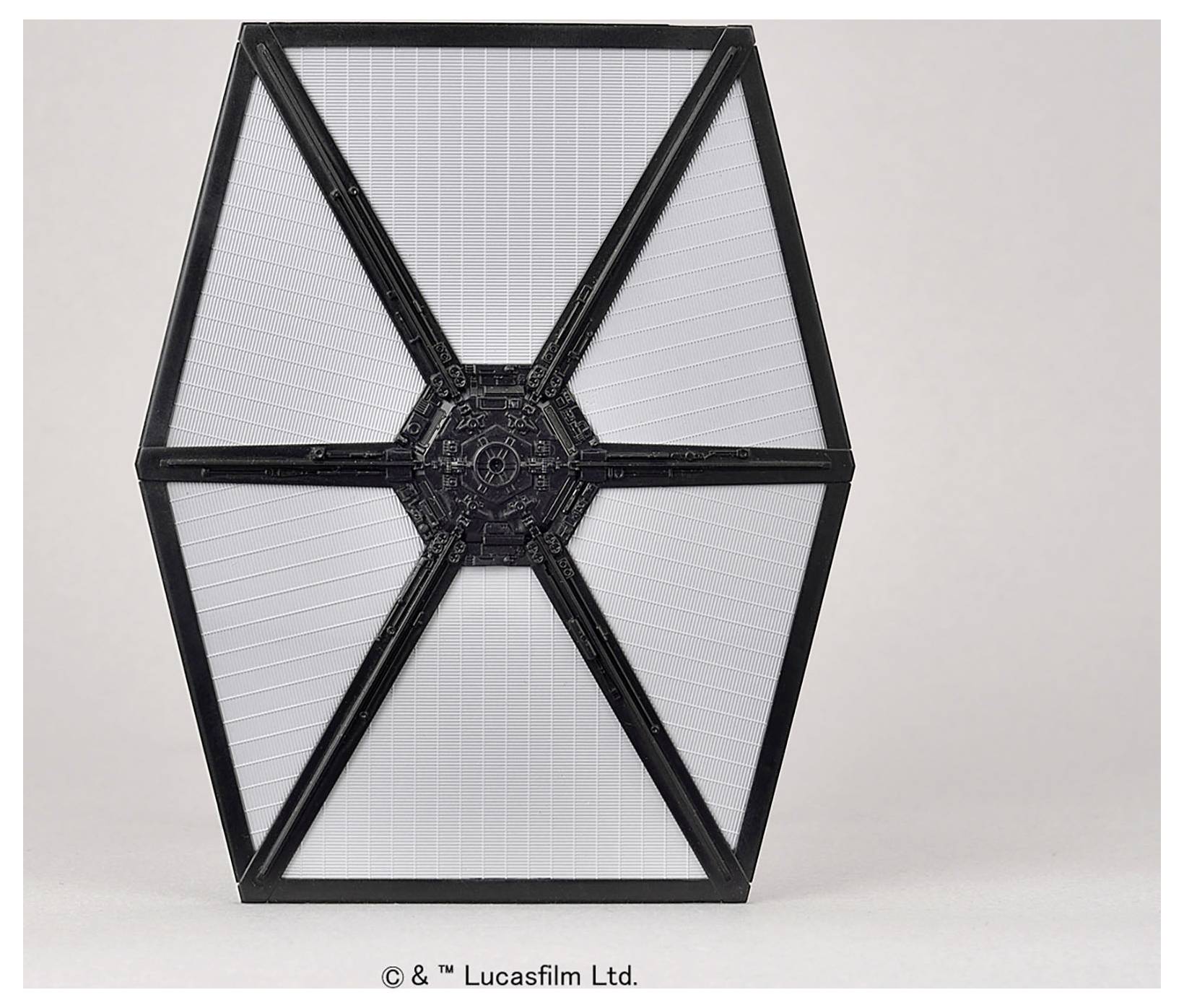 A hexagonal panel with a black frame and central hub, featuring a textured white surface divided into sections by radial lines.