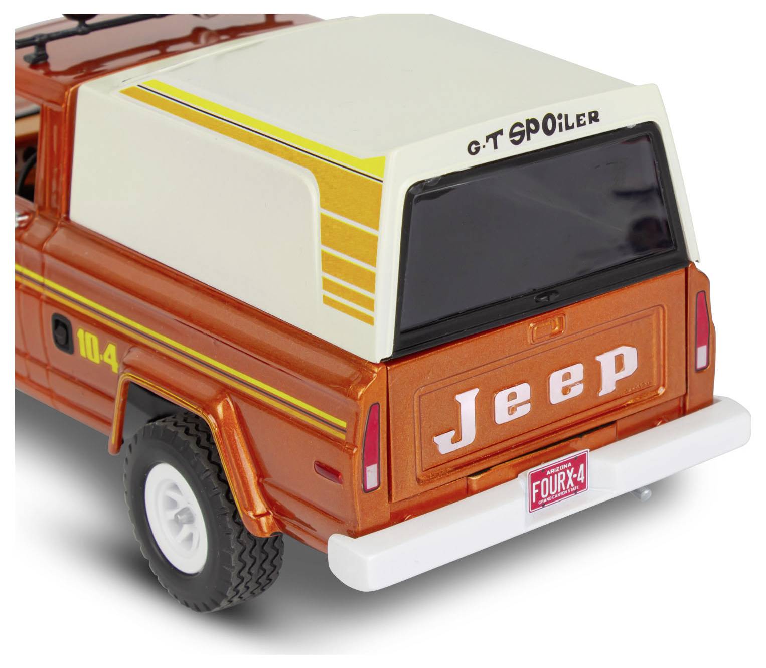 A red vintage-style toy truck with a white camper shell. The back features the word 'Jeep' and a 'FOUR x 4' license plate.