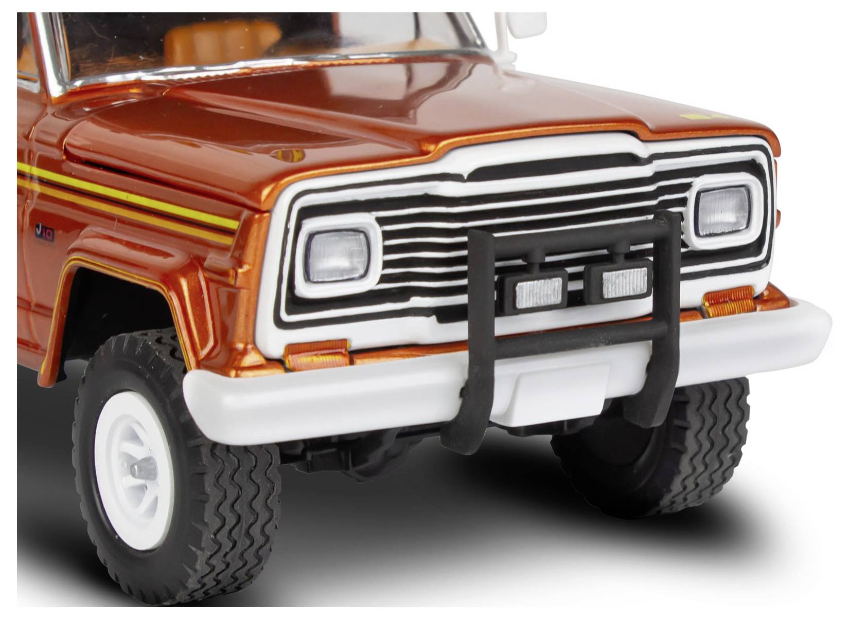 A red toy Jeep with detailed front grille and headlights, featuring off-road tires and black bumper.